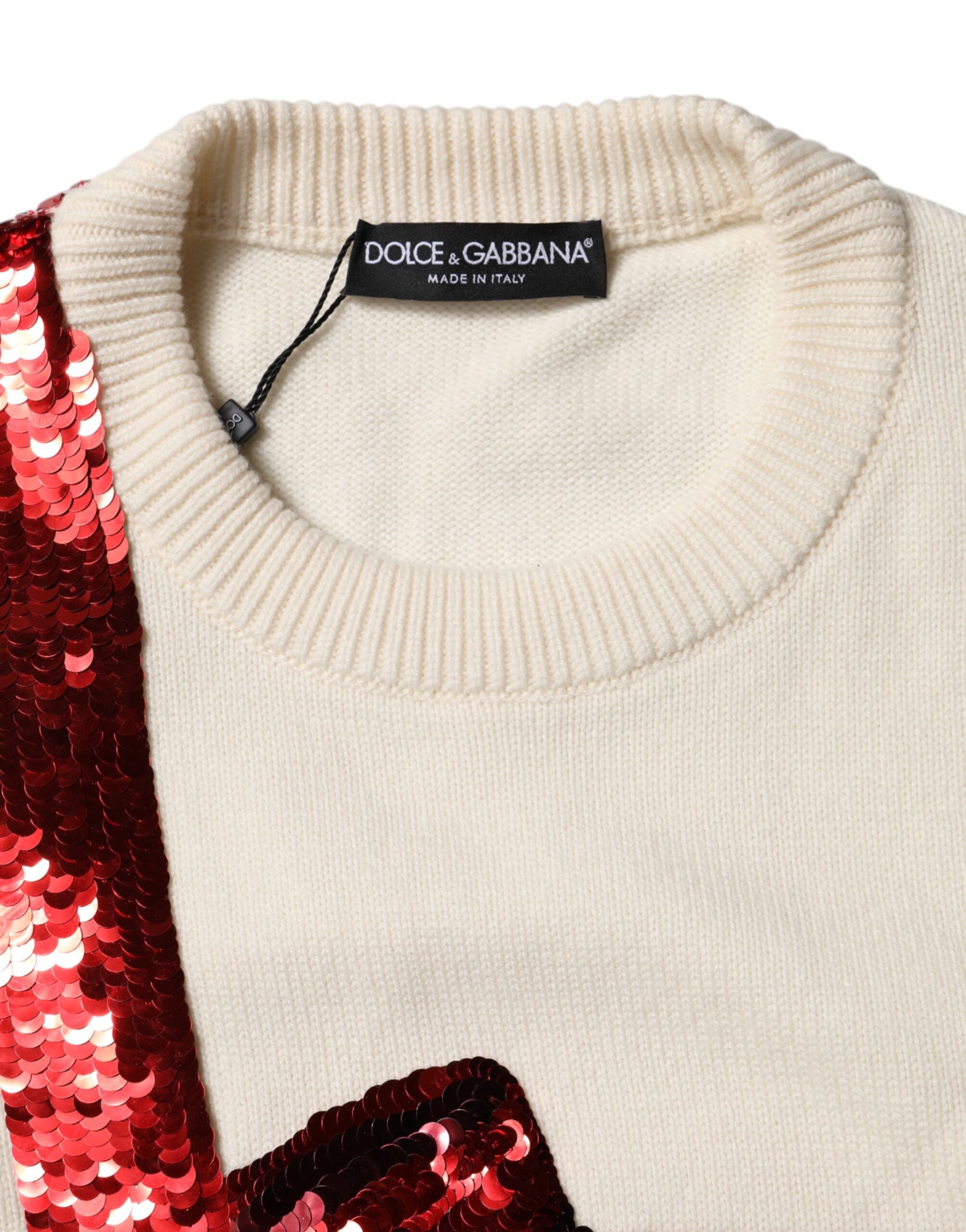 Pull en laine Dolce & Gabbana blanc à sequins, col rond, style élégant et brillant, visible dans l'image.