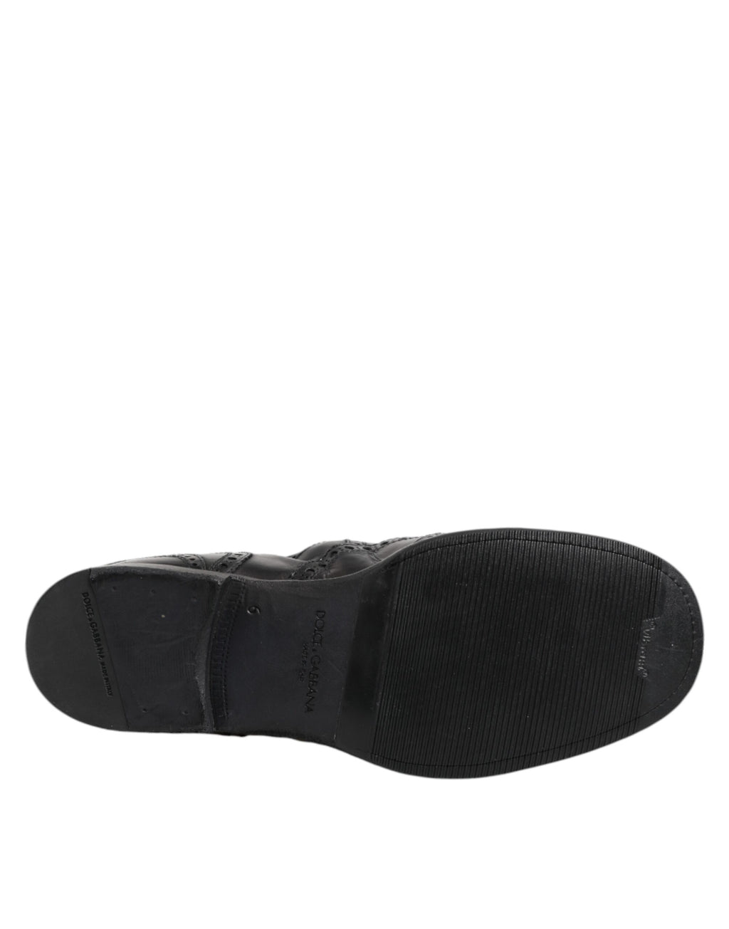 Bottes ankle en cuir noir Dolce & Gabbana, chaussures à enfiler élégantes et modernes, visibles en gros plan sur fond neutre.