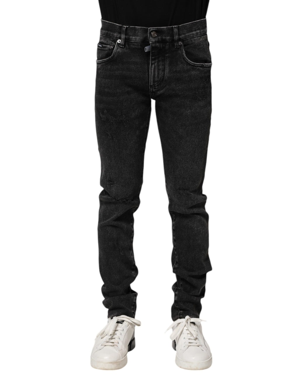 Jeans homme noirs en coton Dolce & Gabbana, coupe skinny, denim épais et tendance, visible en gros plan sur la photo.