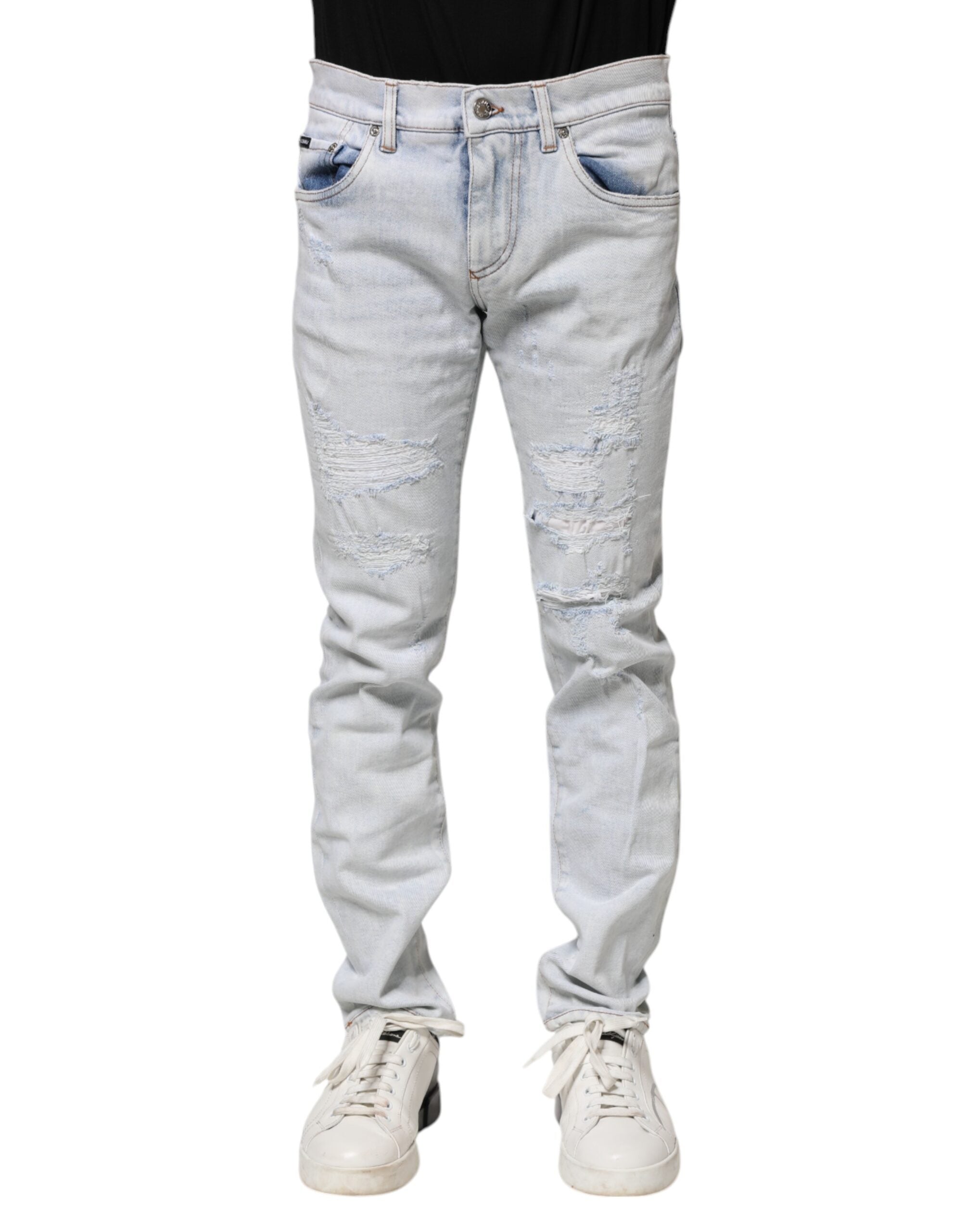 Jeans skinny déchirés en denim Light Blue de Dolce & Gabbana, style décontracté et tendance, visible en détail sur l'image.