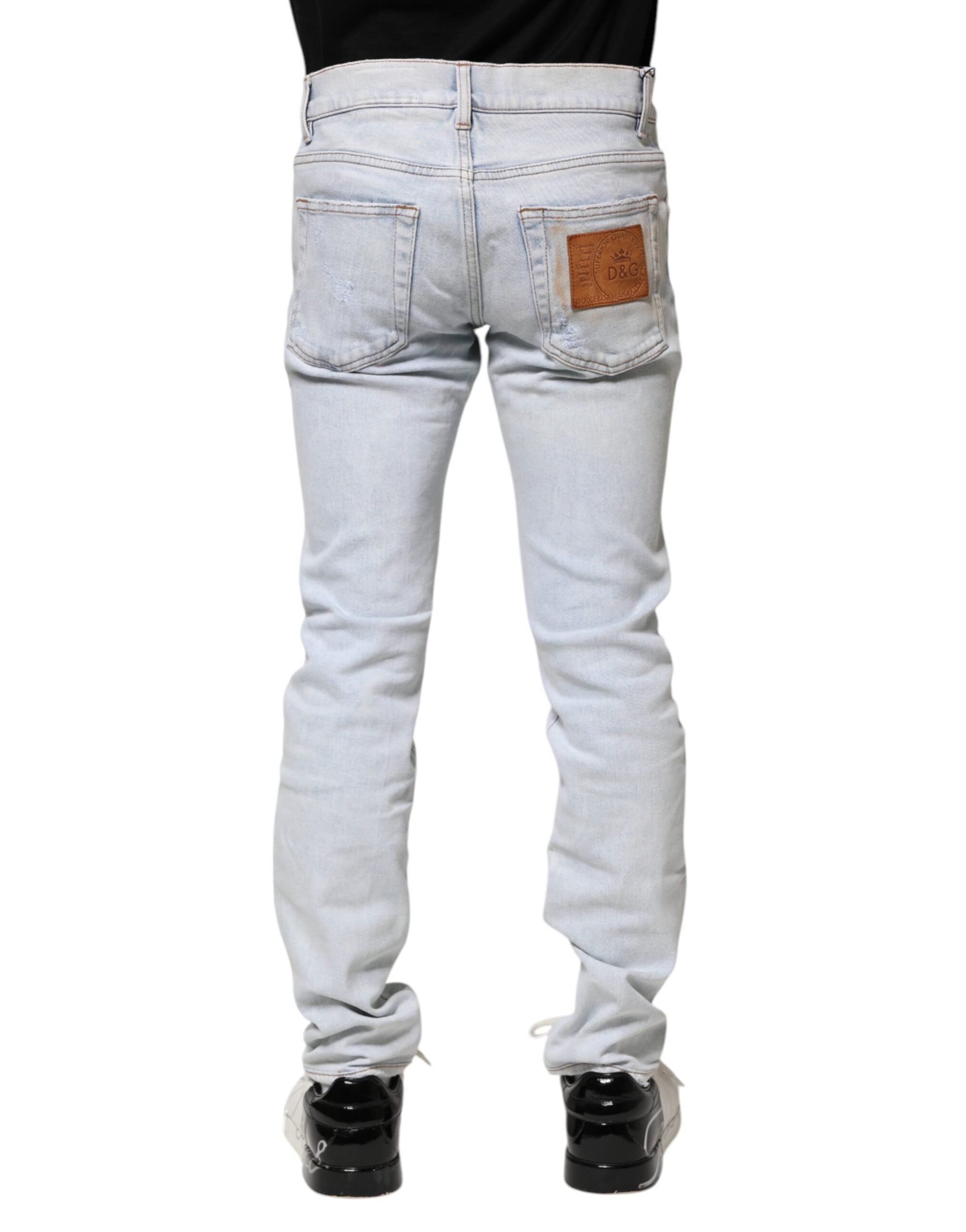 Jeans skinny déchirés Dolce & Gabbana Light Blue en denim bleu clair avec détails usés.