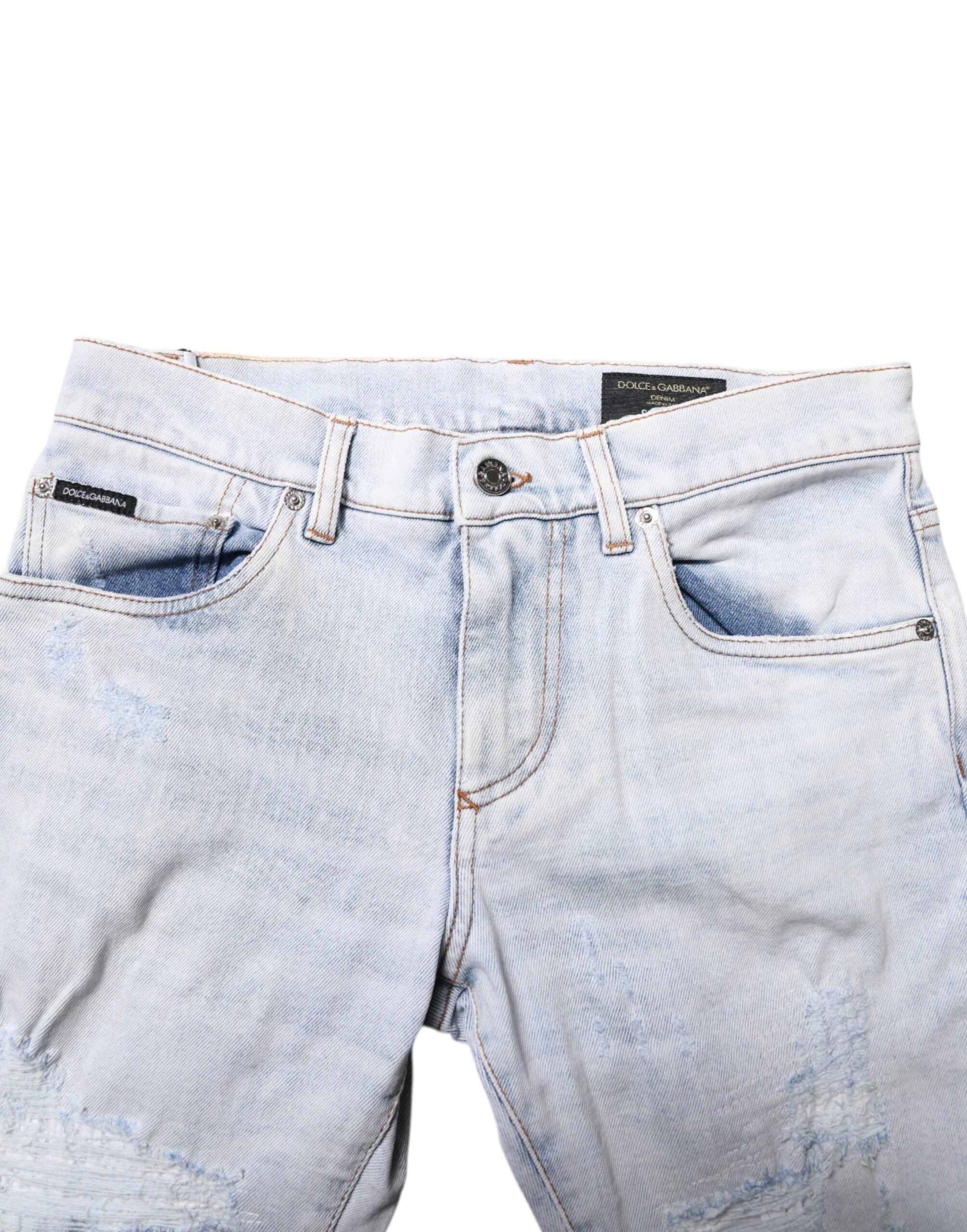 Jeans slim tachetés en denim déchiré Dolce & Gabbana Light Blue, coupe skinny, détails usés visibles.