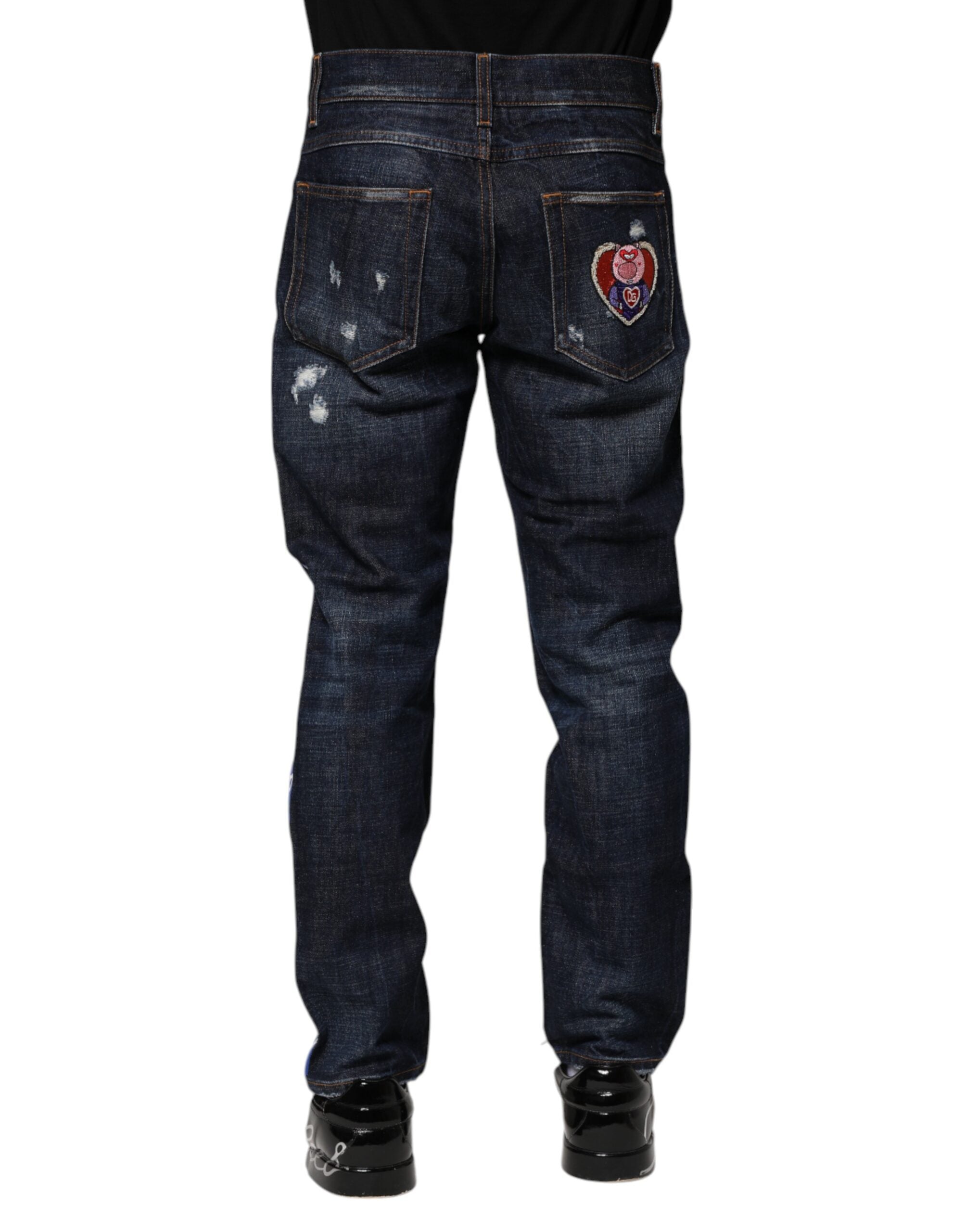 Jeans skinny en denim déchiré bleu foncé de Dolce & Gabbana, coupe ajustée et style moderne.