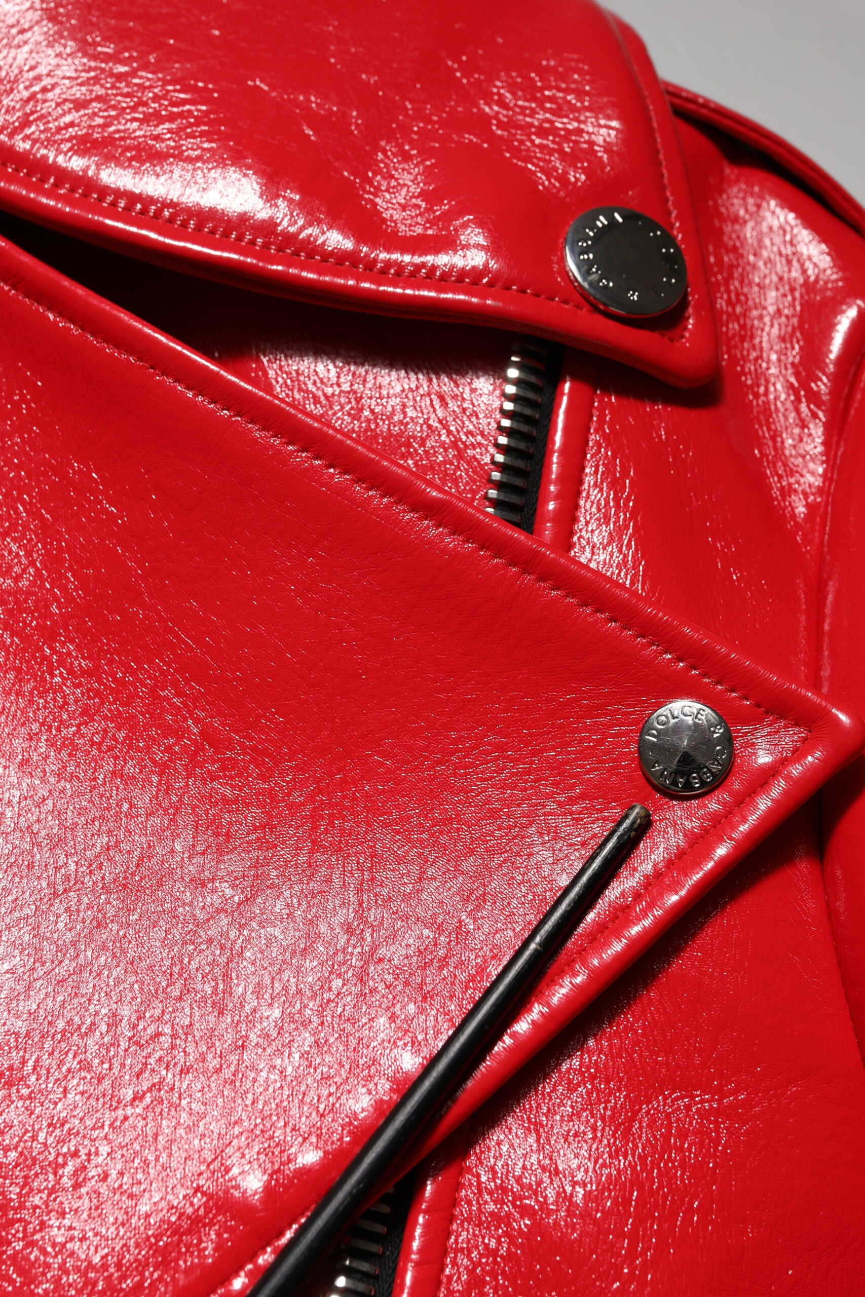 Veste en cuir d'agneau rouge Dolce & Gabbana avec fermeture éclair complète, style élégant et chic.