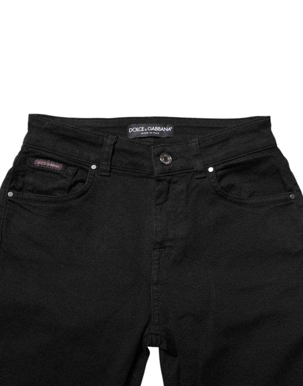 Jeans skinny noirs en coton Dolce & Gabbana, taille mi-haute, portés sur un mannequin avec un fond neutre.