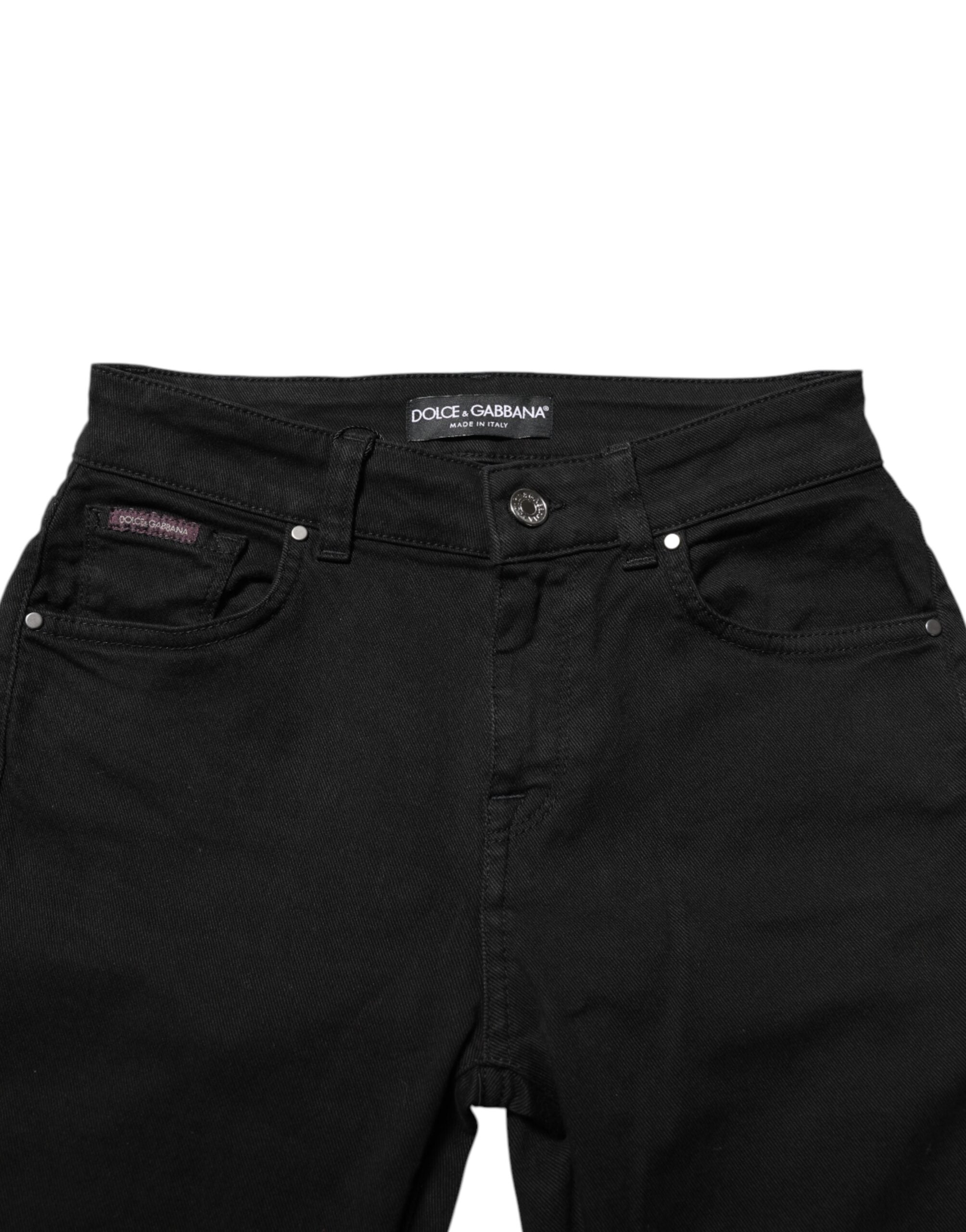 Jeans skinny noirs en coton Dolce & Gabbana, taille mi-haute, portés sur un mannequin avec un fond neutre.