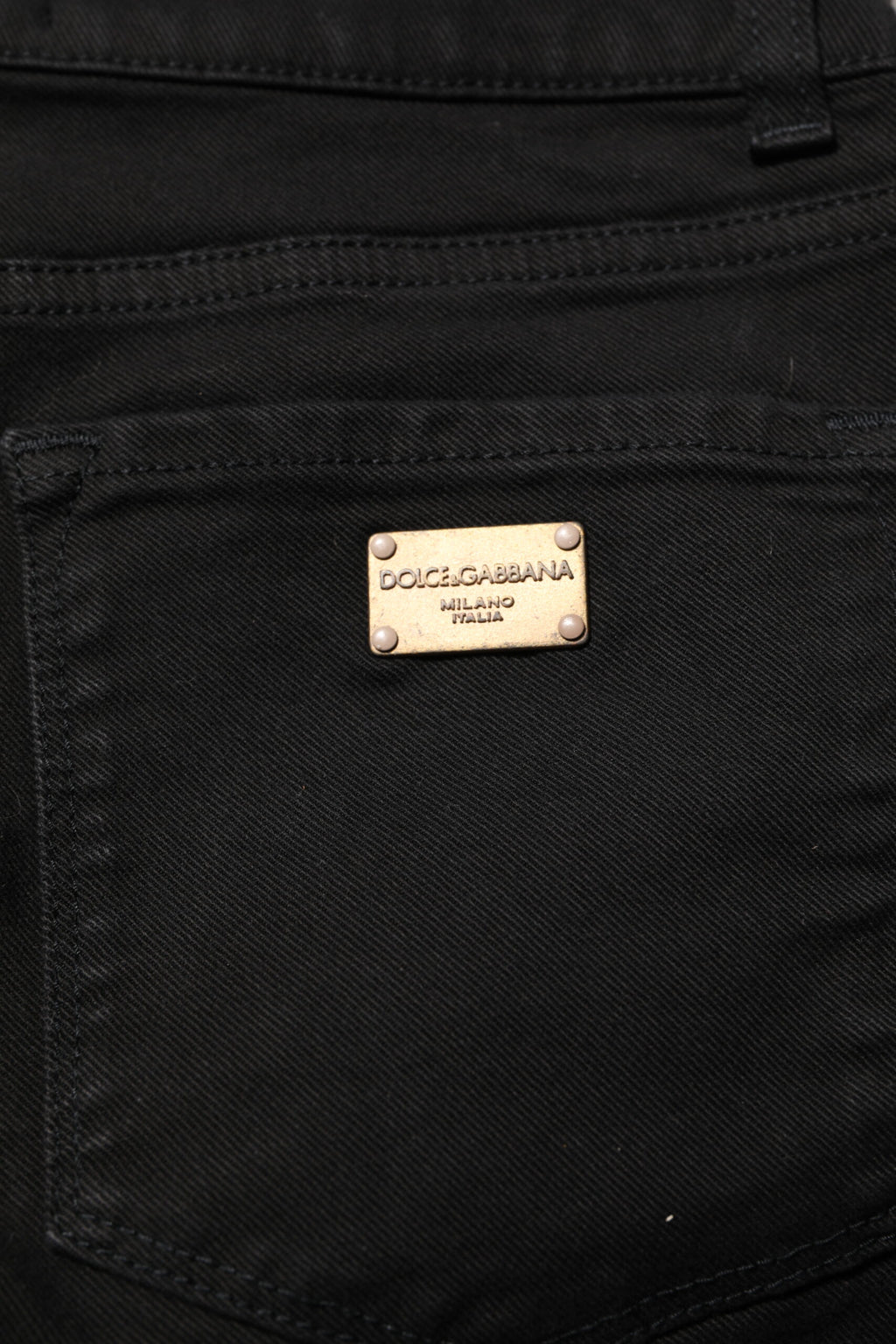 Jeans slim en coton noir Dolce & Gabbana, taille mi-haute, coupe skinny, denim tendance visible sur l'image.