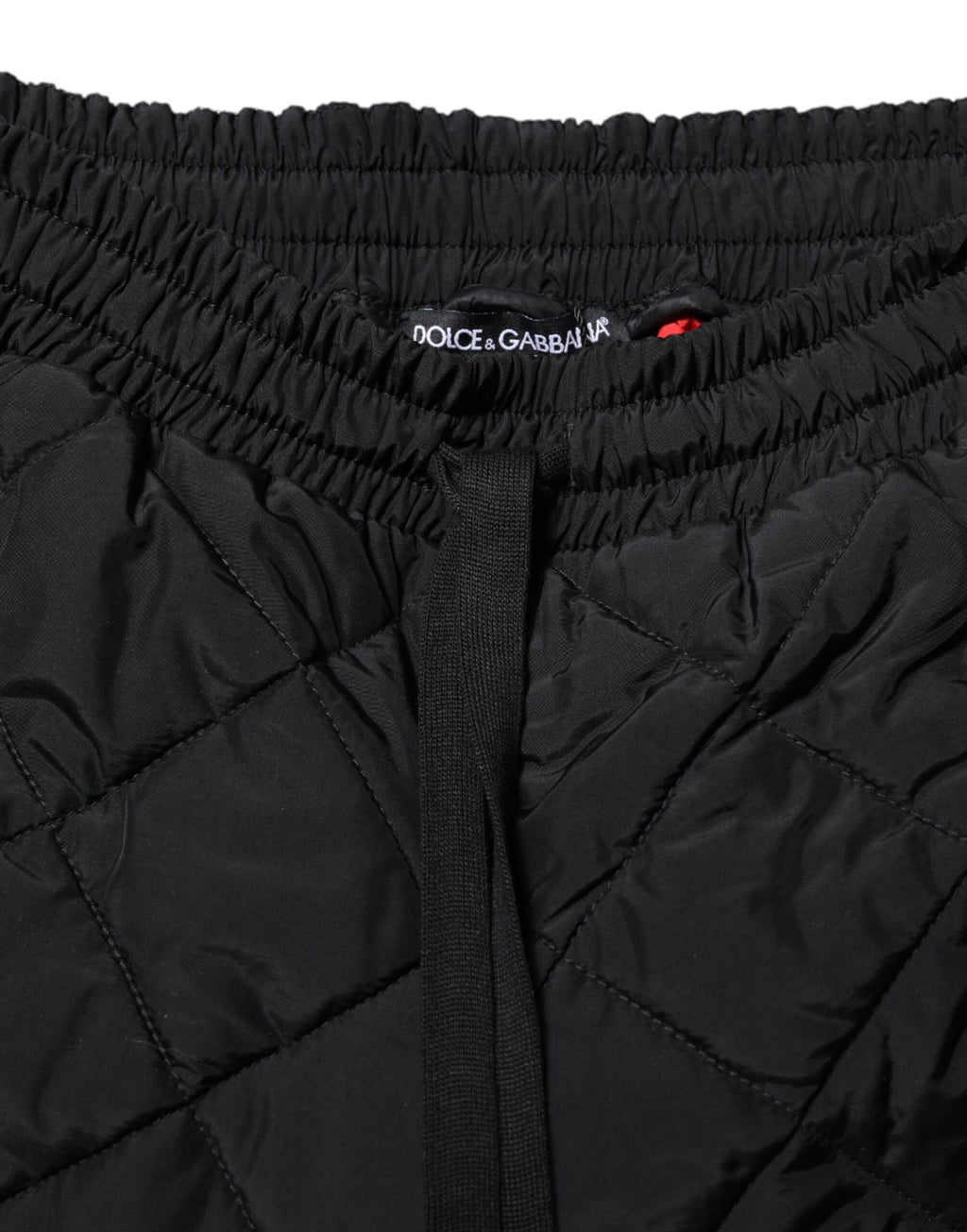 Pantalons joggers noirs Dolce & Gabbana en tissu matelassé à taille moyenne, mode élégante et confortable.