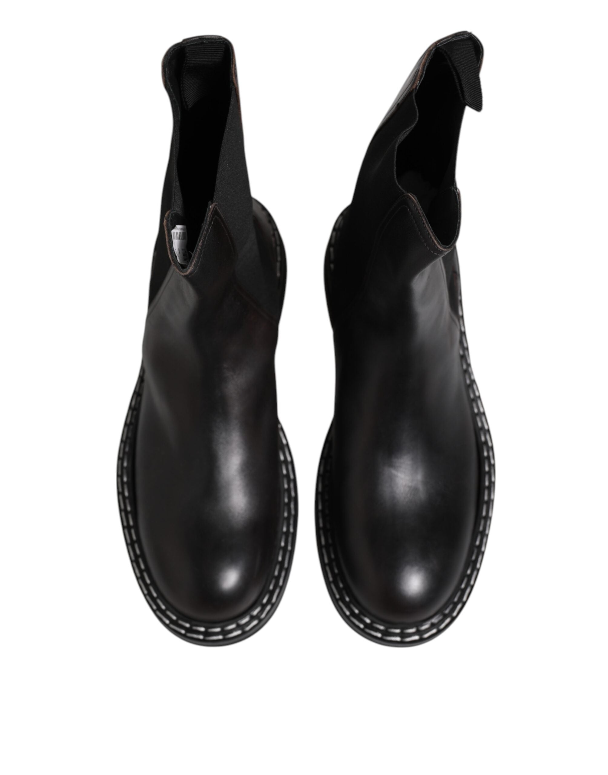 Bottes plates en cuir noir Dolce & Gabbana, mi-mollet, avec design élégant et finition lisse.