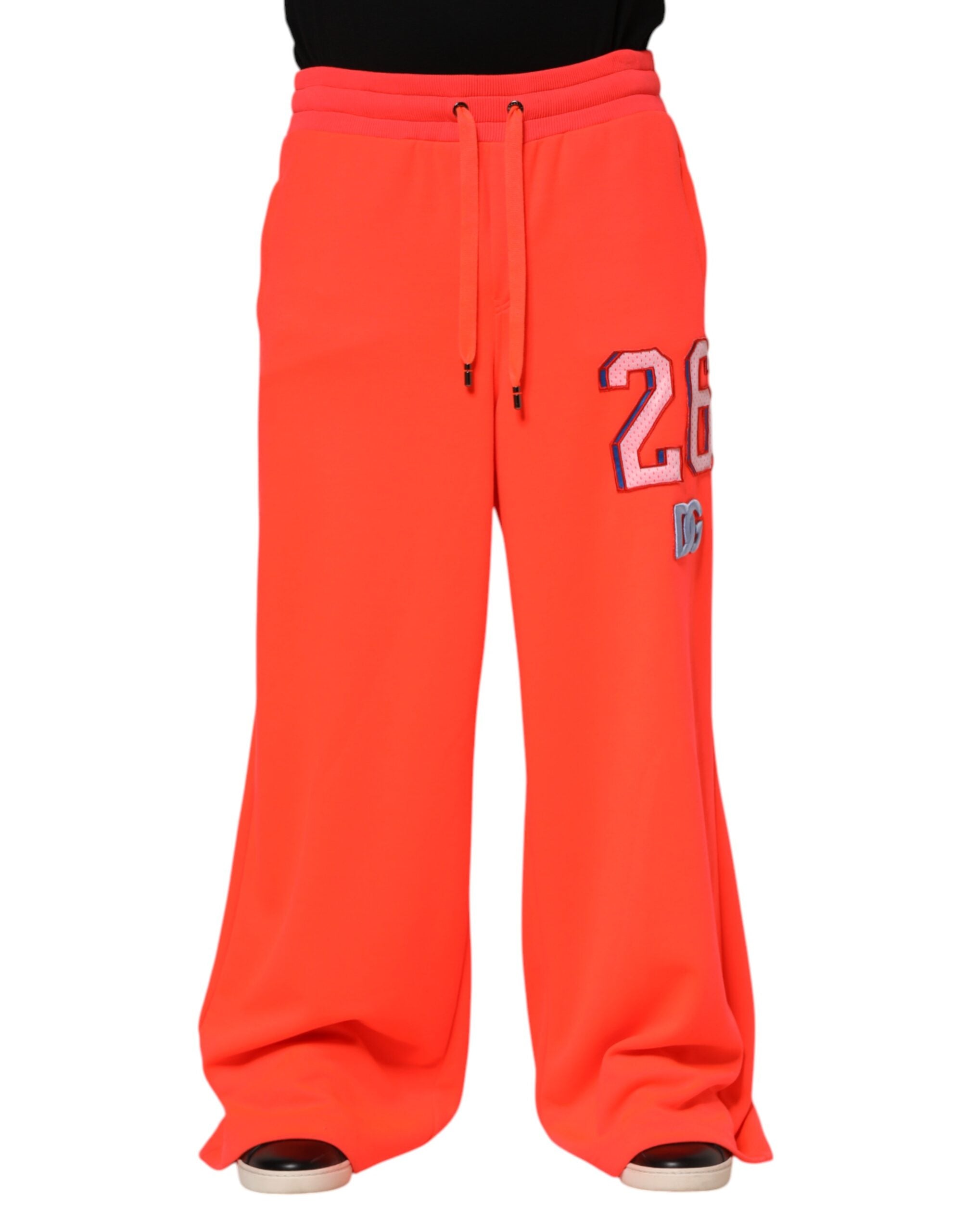 Pantalon jogging pour homme Dolce & Gabbana en polyester orange, style décontracté avec ceinture élastique et poches latérales.