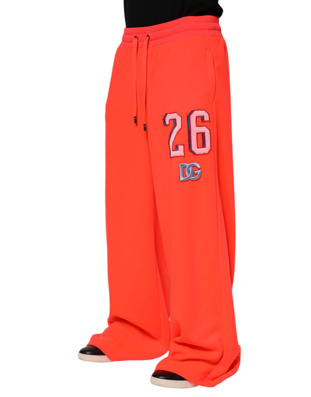 Pantalon de jogging polyester orange pour homme Dolce & Gabbana, style décontracté avec ceinture élastique et poches latérales.