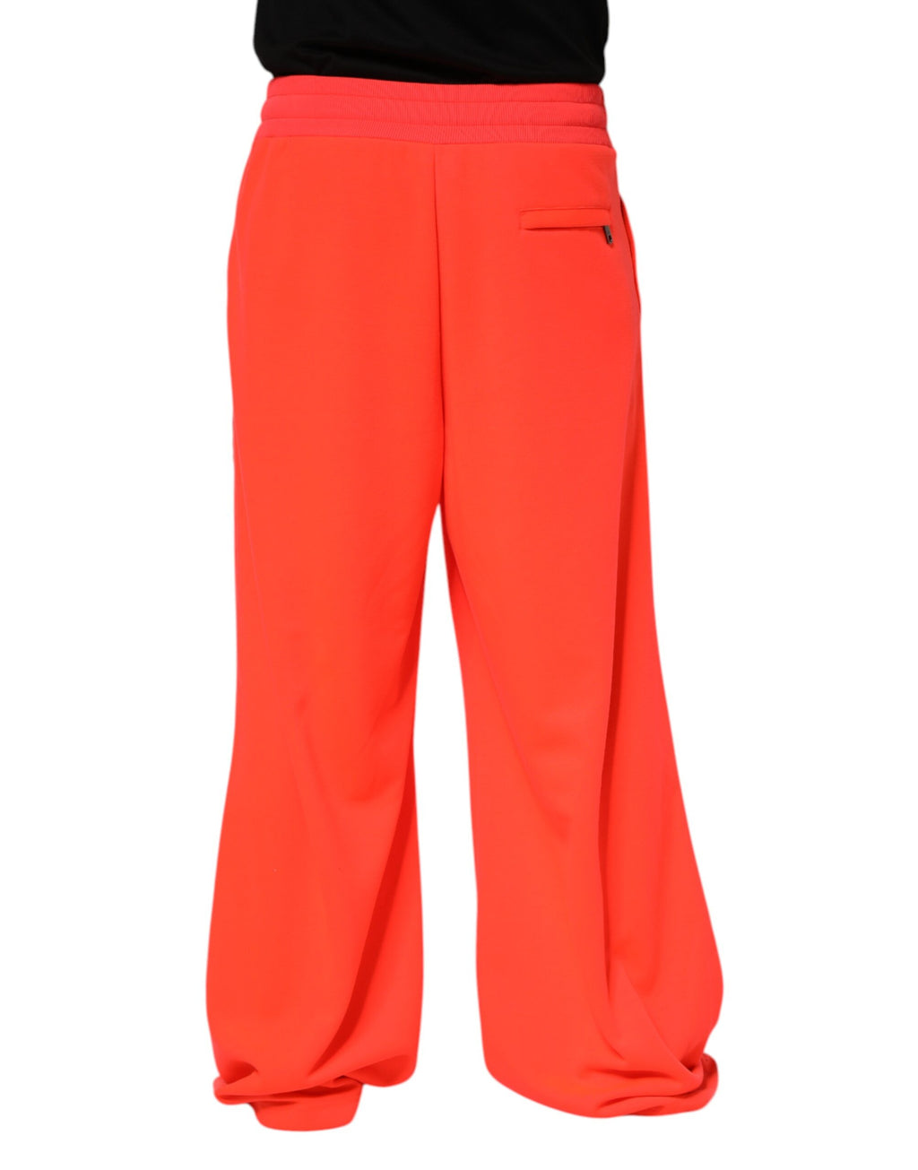 Pantalon de jogging homme Dolce & Gabbana en polyester orange, style décontracté avec ceinture élastique et poches latérales.