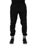 Pantalons joggers pour homme Dolce & Gabbana en coton noir avec bande logo, tendance et confortables.