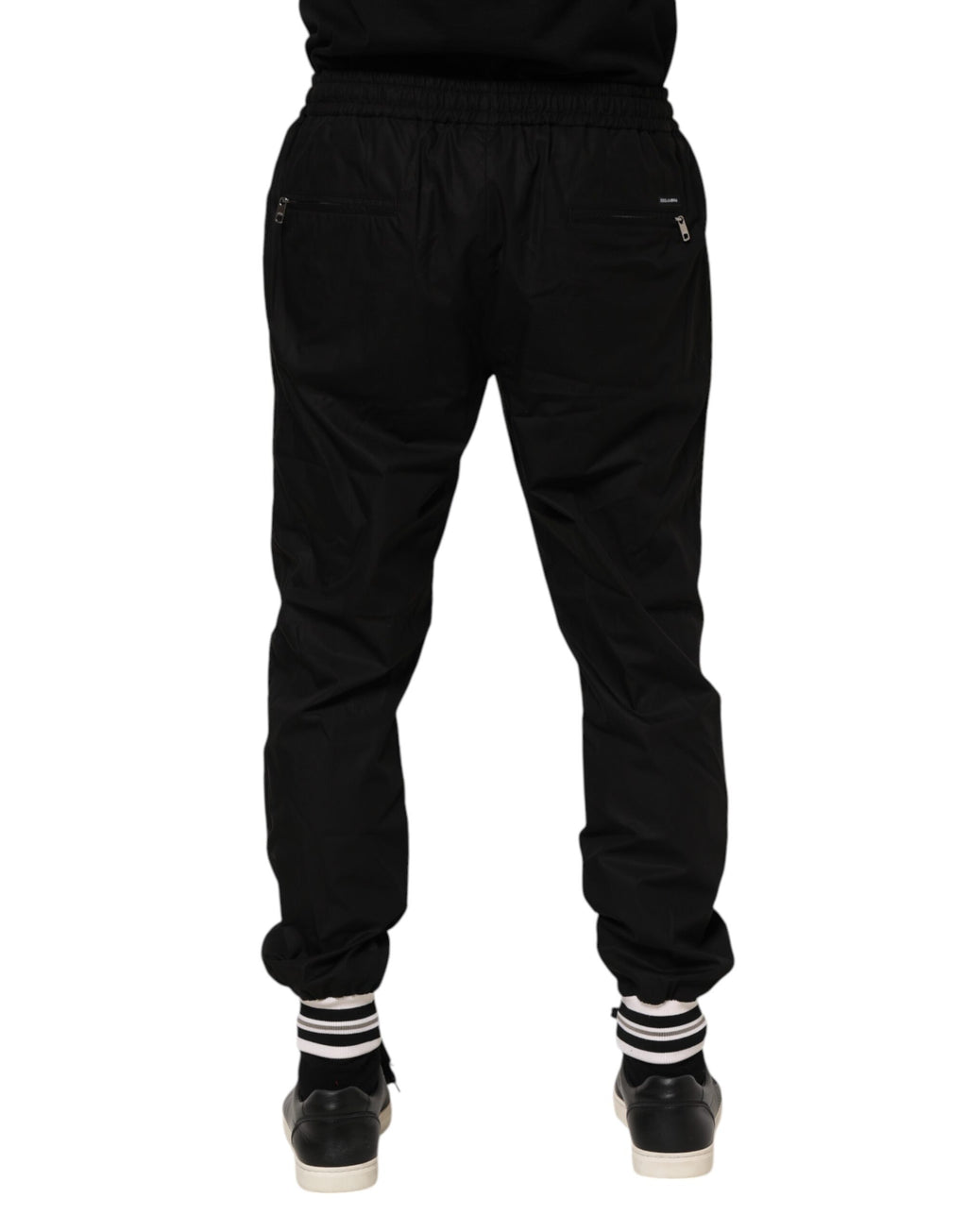 Pantalons jogger pour homme Dolce & Gabbana en coton noir avec bande logo, style décontracté et élégant.