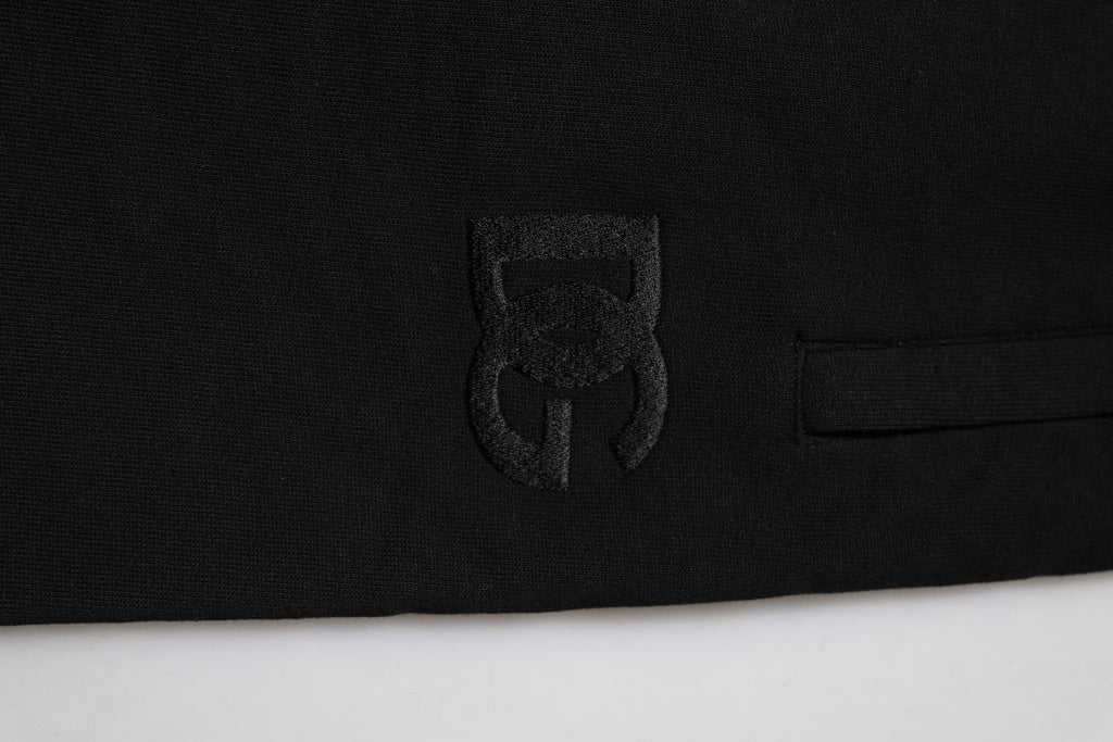 Pantalon jogger homme Dolce & Gabbana en coton noir avec bande logo, style décontracté et confortable.