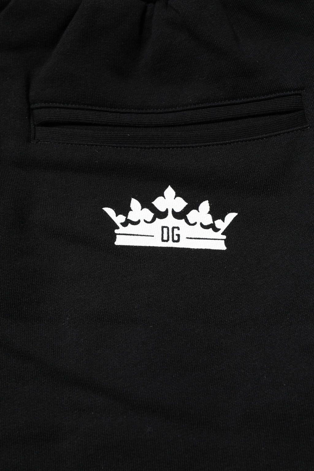 Pantalons joggers Dolce & Gabbana en coton noir avec motif couronne, style décontracté et élégant.