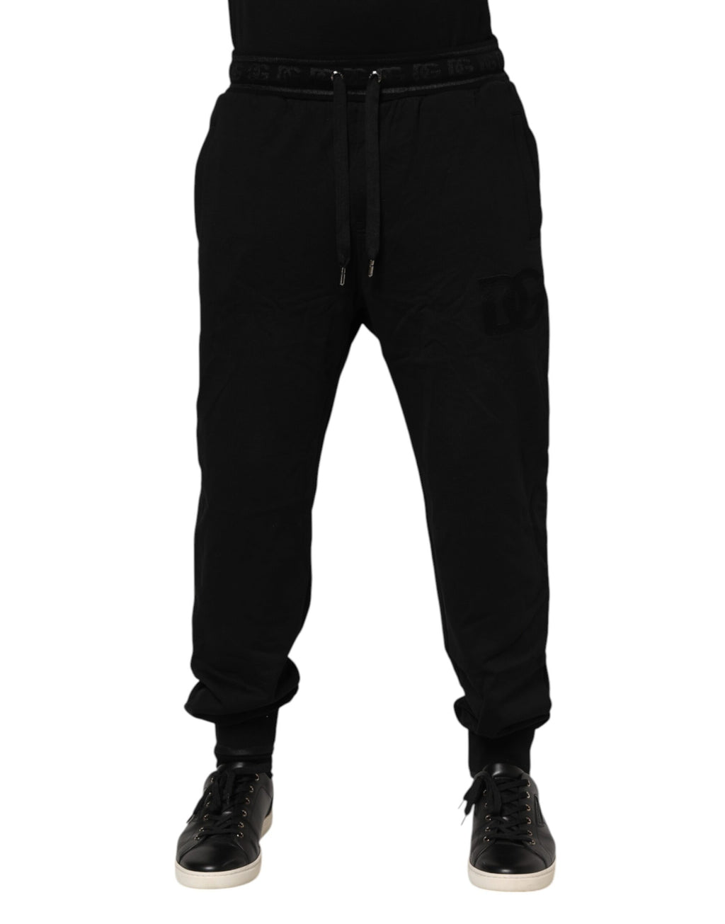 Pantalons joggers en coton noir Dolce & Gabbana avec cordon de serrage et coupe décontractée, visibles sur l'image.