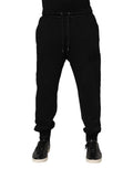 Pantalons joggers en coton noir Dolce & Gabbana avec cordon de serrage et coupe décontractée, visibles sur l'image.