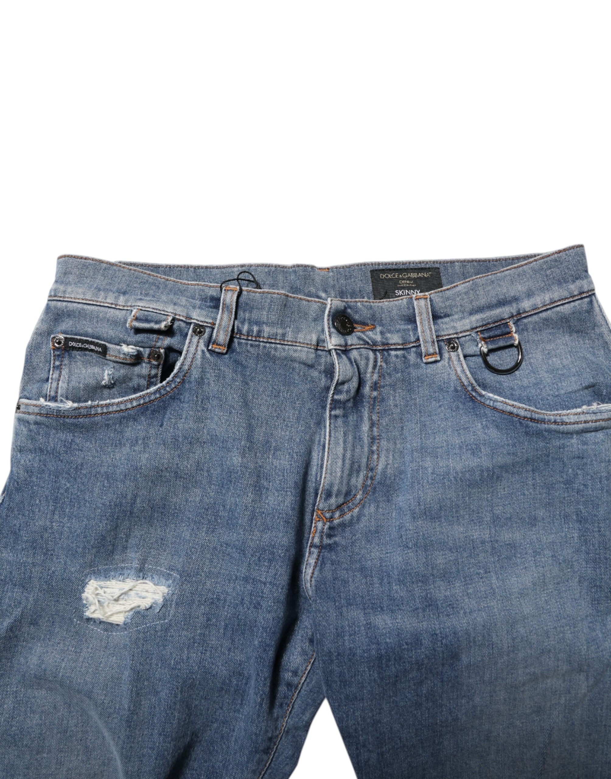 Jeans skinny en denim bleu Dolce & Gabbana avec déchirures et logo, tissu en coton, style décontracté et tendance.