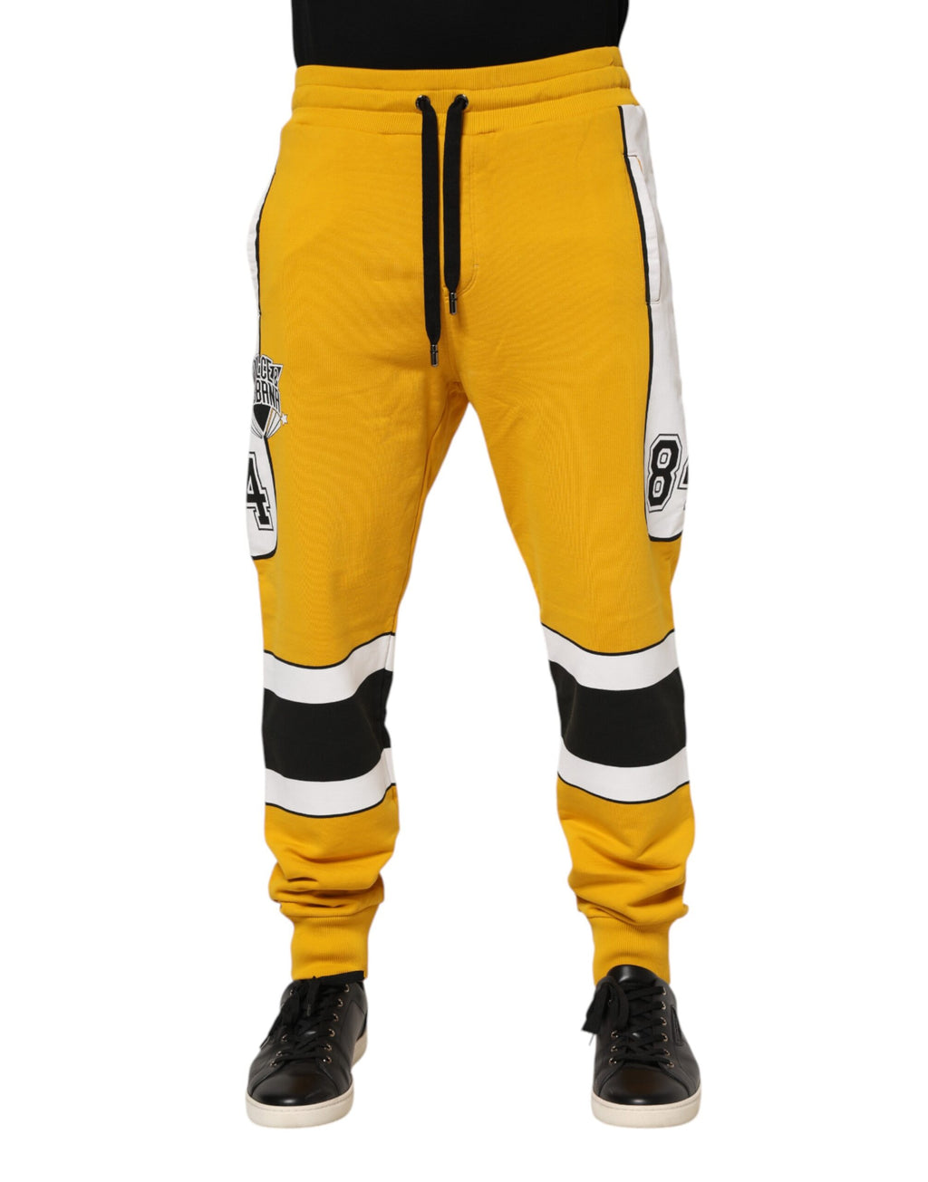 Pantalons jogger en coton jaune avec cordon de serrage de Dolce & Gabbana, visibles avec poches et détails décontractés.