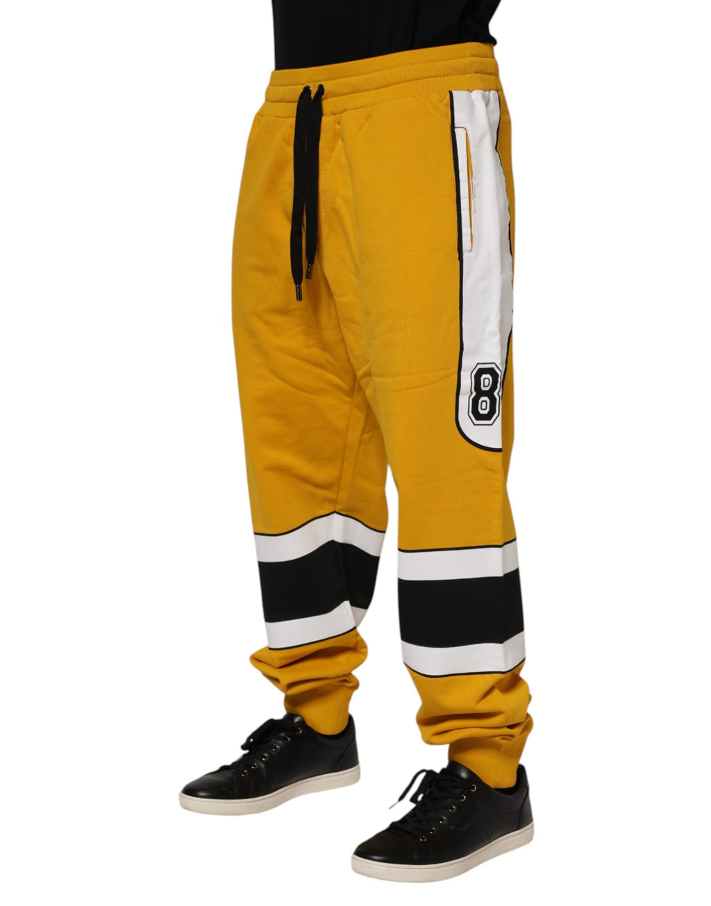 Pantalon de jogging en coton jaune Dolce & Gabbana avec logo, cordon de serrage et style décontracté visible sur l'image.