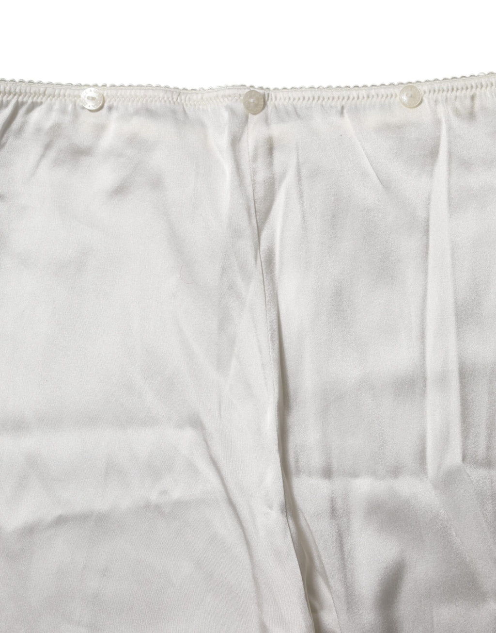 Pantalons en soie ivoire à taille haute et coupe fuselée de Dolce & Gabbana, élégants et sophistiqués.