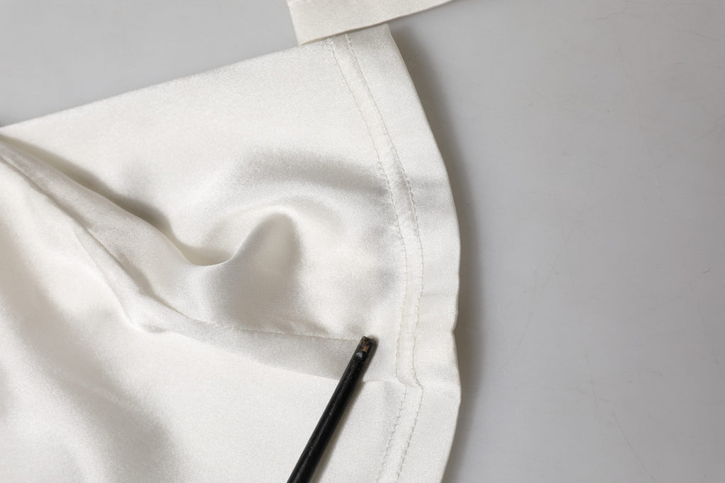 Pantalons en soie ivoire Dolce & Gabbana taille haute et tapered, vue de face avec détails élégants et couture raffinée.