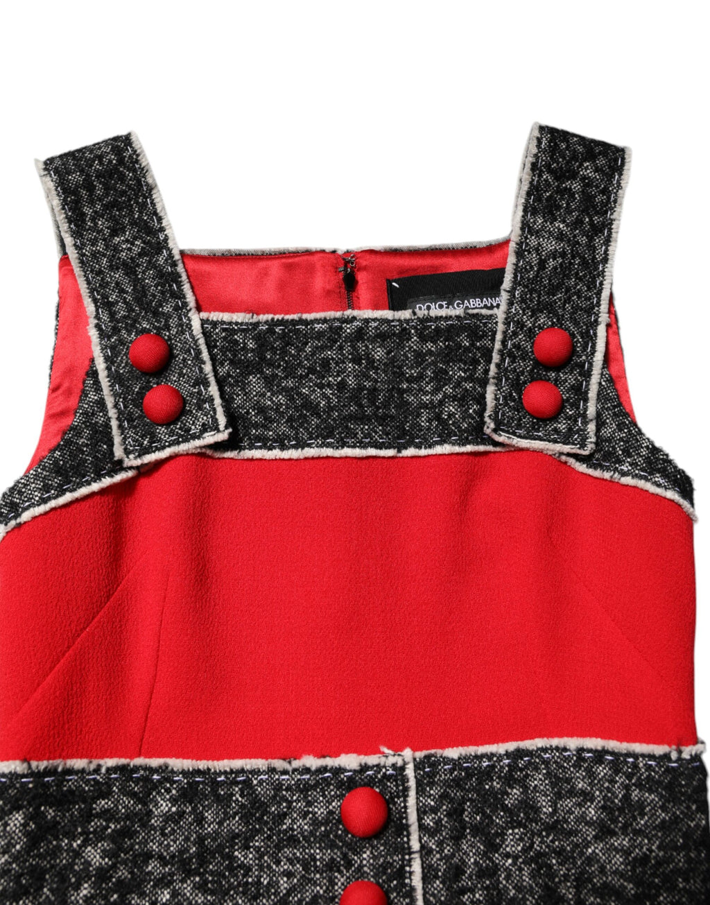 Robe sans manches en laine rouge Dolce & Gabbana, coupe évasée et style mini A-line, portée élégante et moderne.