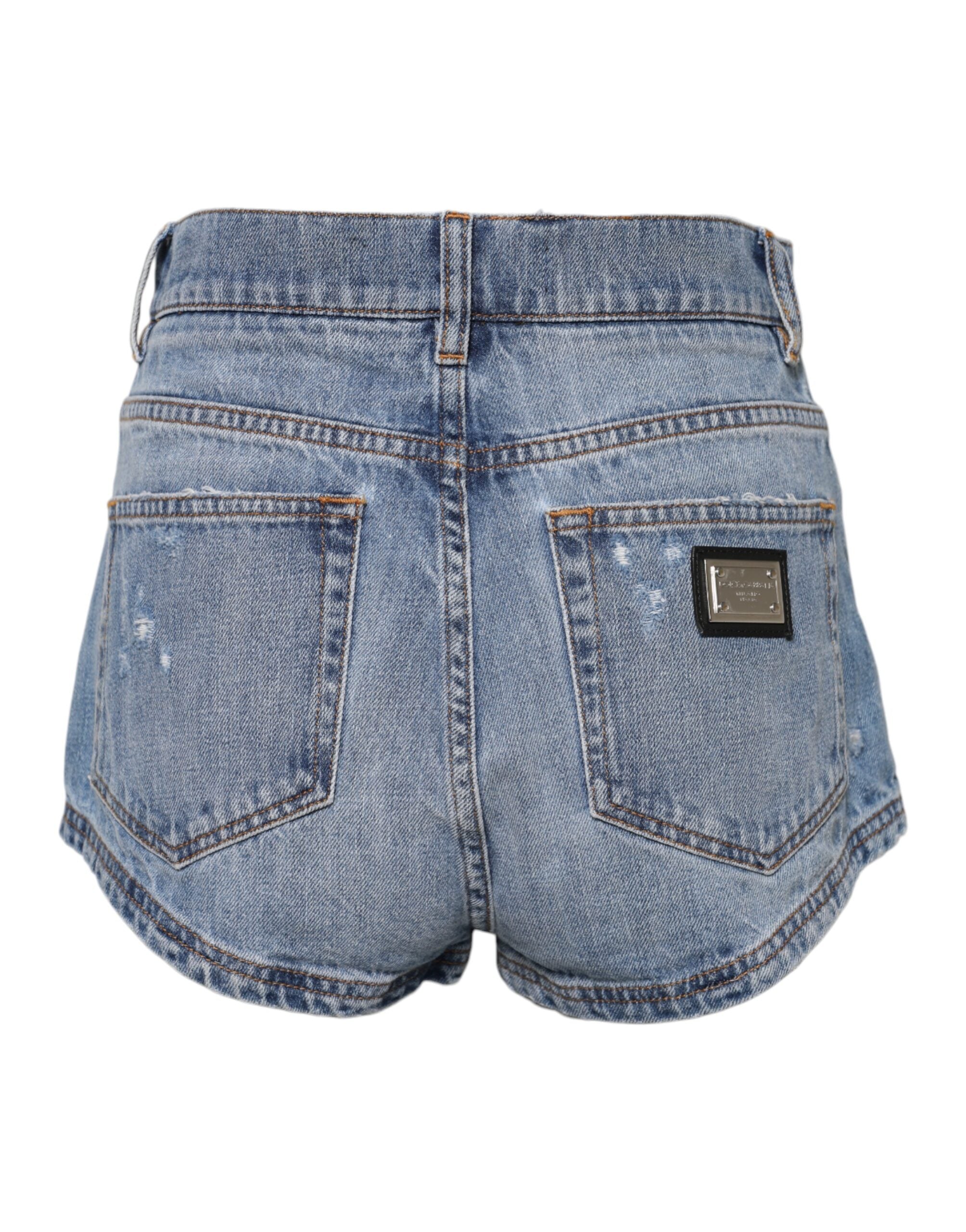 Shorts en denim coton Dolce & Gabbana avec logo bleu et plaque, style hot pants, visibles en image.