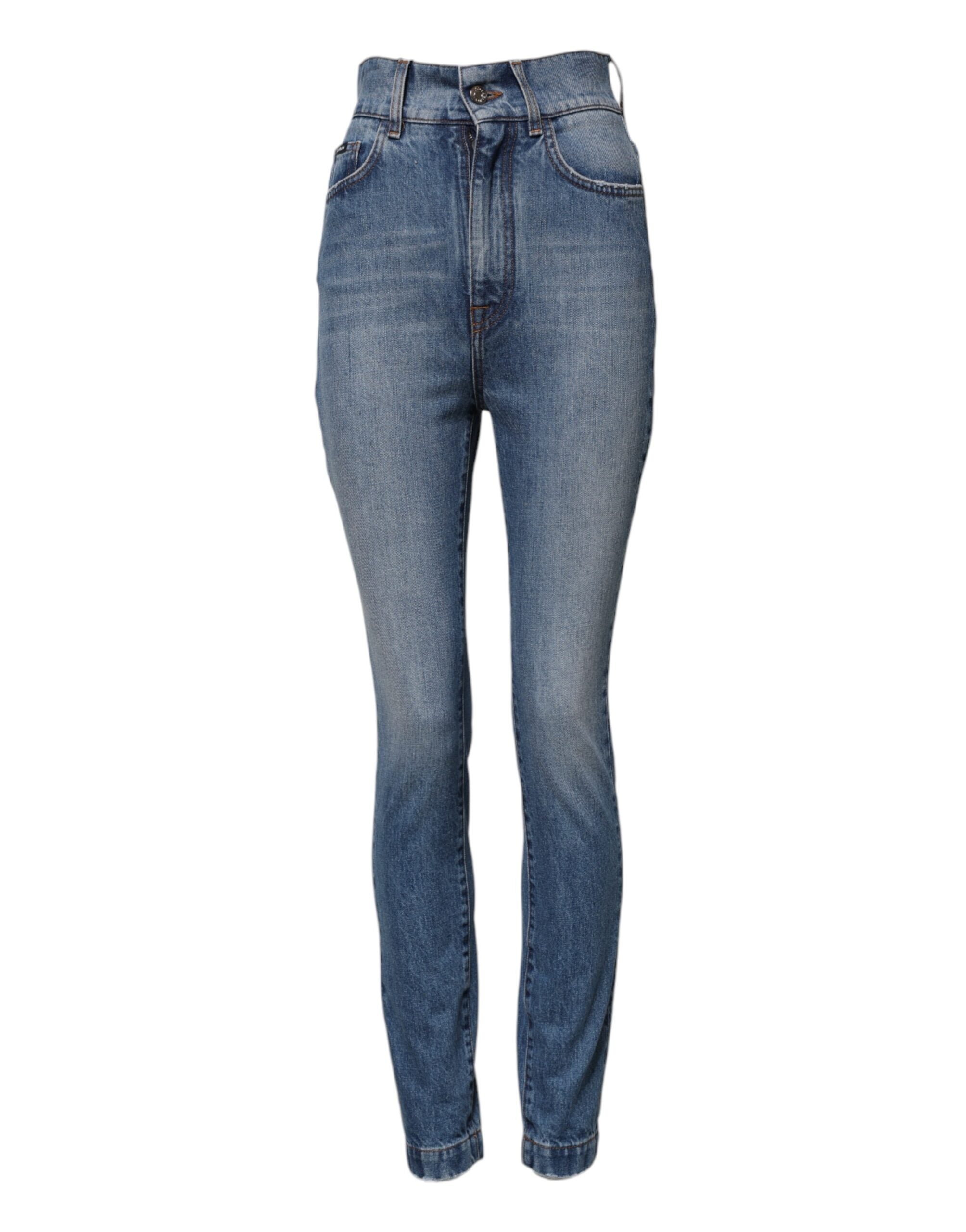 Jeans en denim bleu délavé Dolce & Gabbana, coupe skinny taille haute, visibles avec détails de couture et boutons.