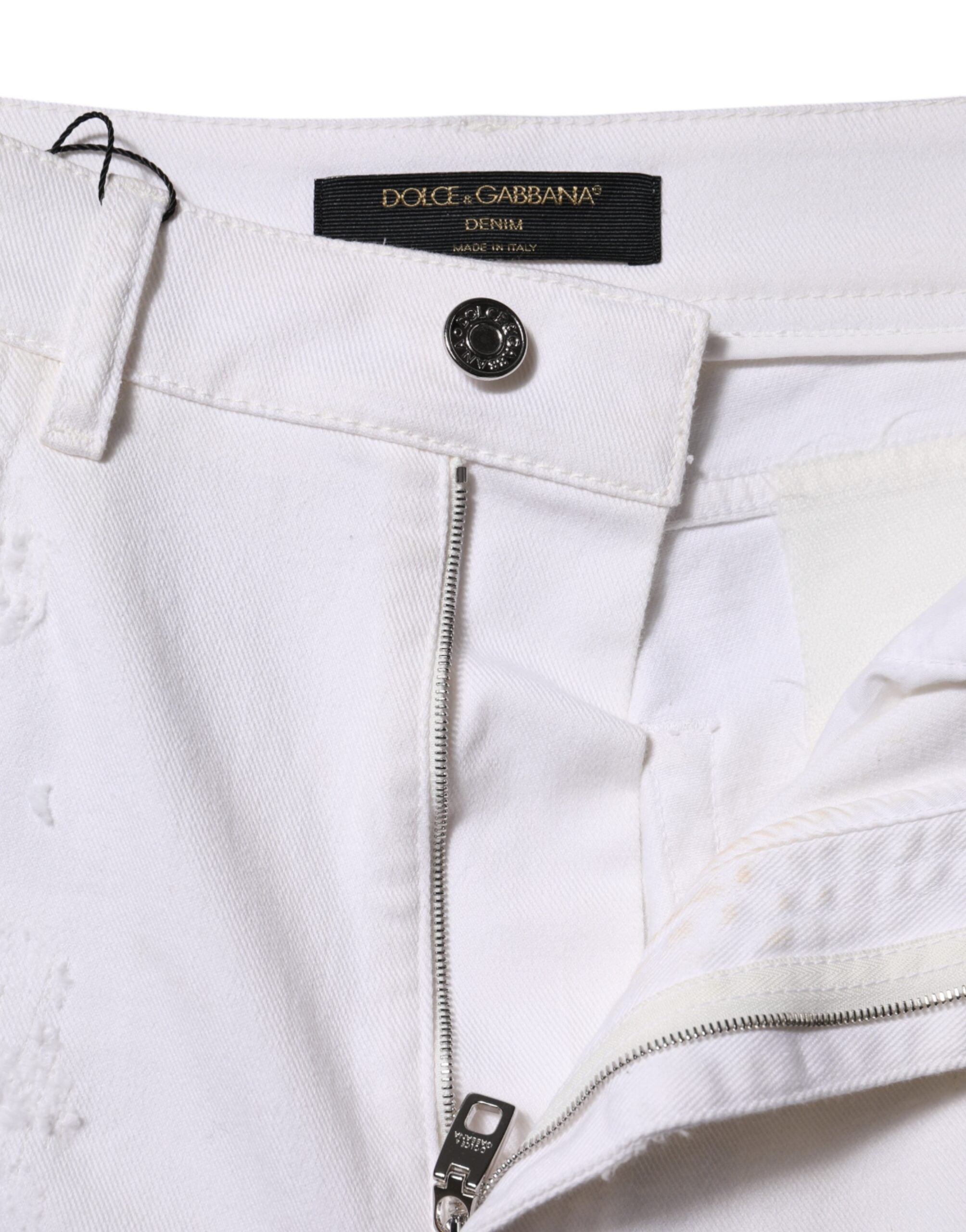 Jeans en denim blanc taille haute de Dolce & Gabbana avec déchirures et style décontracté.