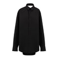 Robe longue noire en coton de Balenciaga, élégante et fluide, portée avec un design moderne et sophistiqué.