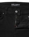 Jeans skinny en coton noir Dolce & Gabbana avec logo, taille mi-haute, denim tendance visible sur l'image.