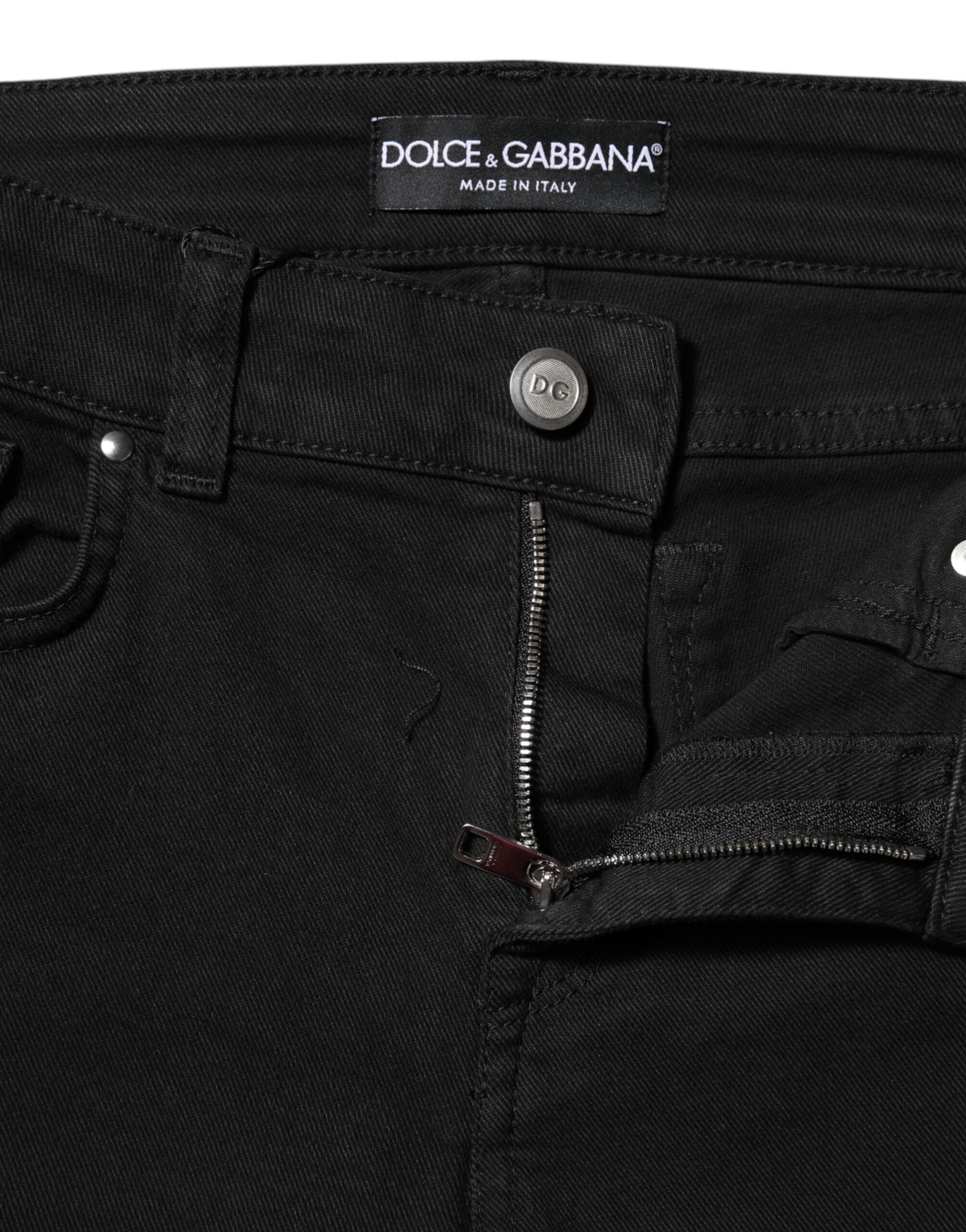 Jeans skinny en coton noir Dolce & Gabbana avec logo, taille mi-haute, denim tendance visible sur l'image.
