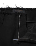 Jeans en denim noir Dolce & Gabbana, coupe évasée à taille moyenne, en coton, visible avec détails de couture.
