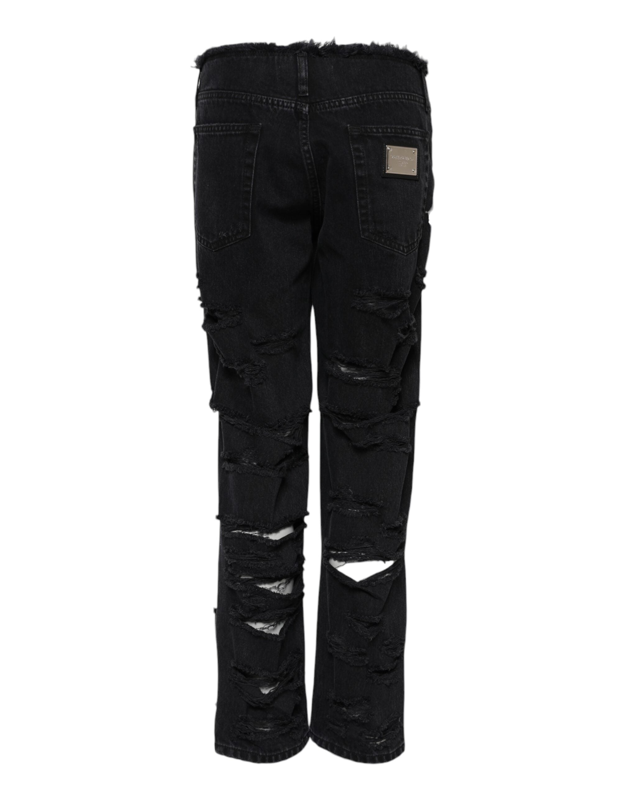 Jeans en denim noir Dolce & Gabbana, déchirés, taille mi-hauteur, style décontracté, visible en gros plan.