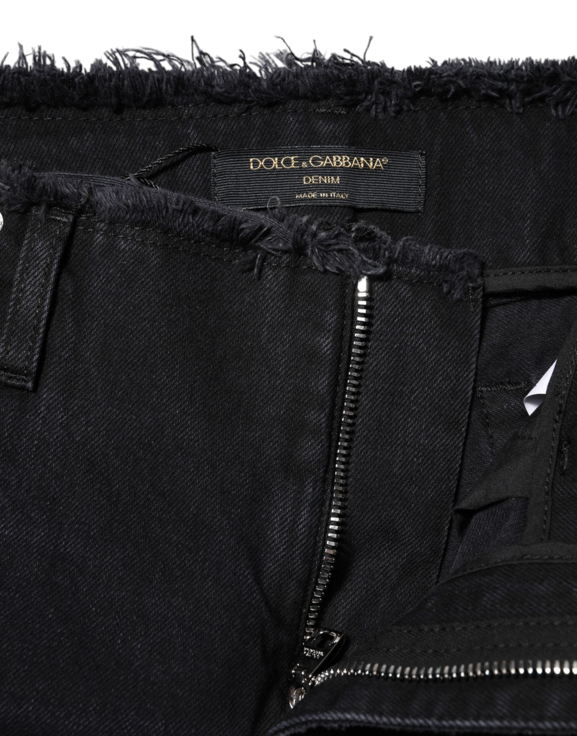Jeans en coton noir Dolce & Gabbana, déchirés, taille moyenne, denim tendance visible en détail dans l'image.