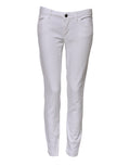 Jeans en denim blanc Dolce & Gabbana, coupe skinny taille basse, en coton, visible avec détails de couture et fermeture éclair.