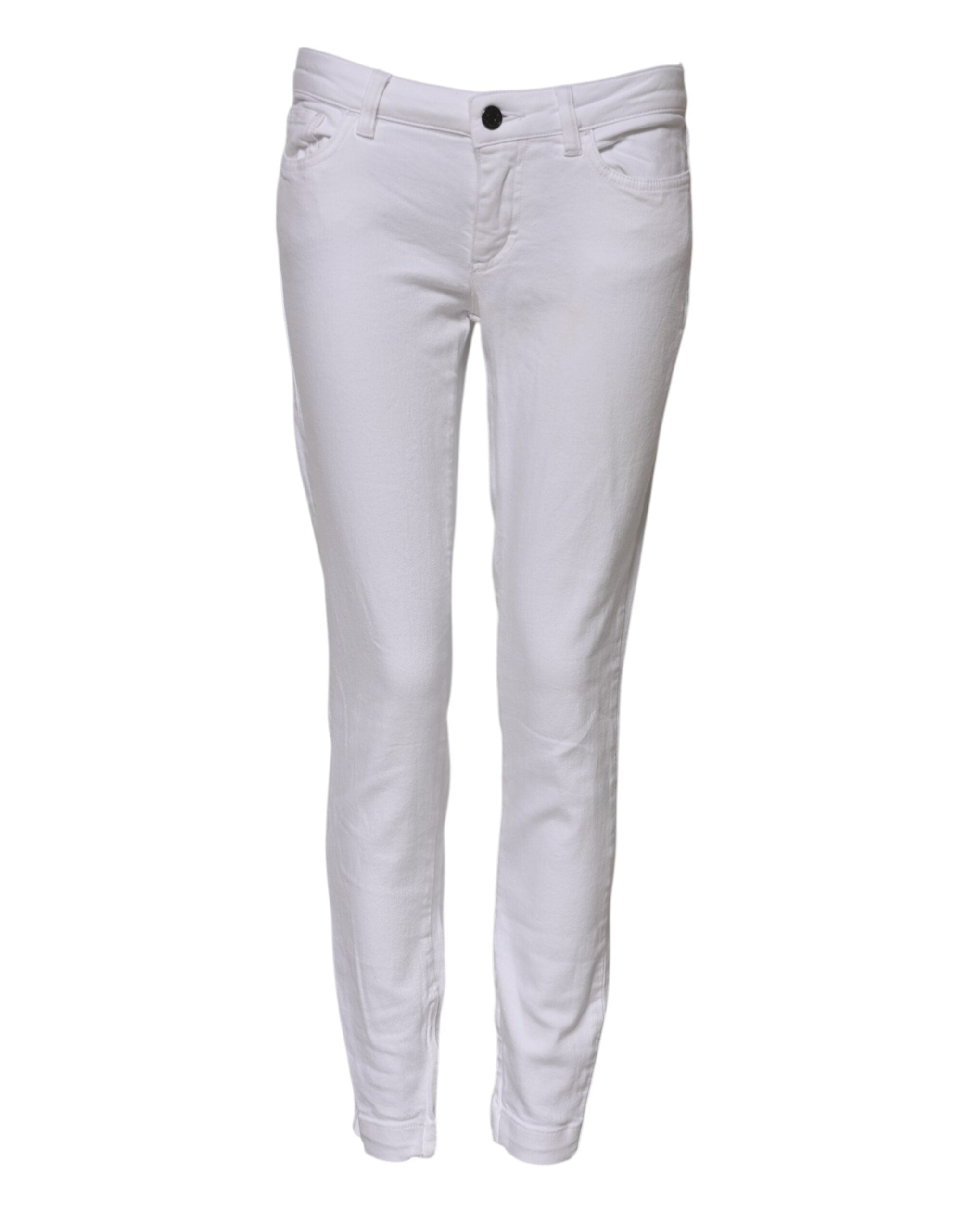 Jeans en denim blanc Dolce & Gabbana, coupe skinny taille basse, en coton, visible avec détails de couture et fermeture éclair.
