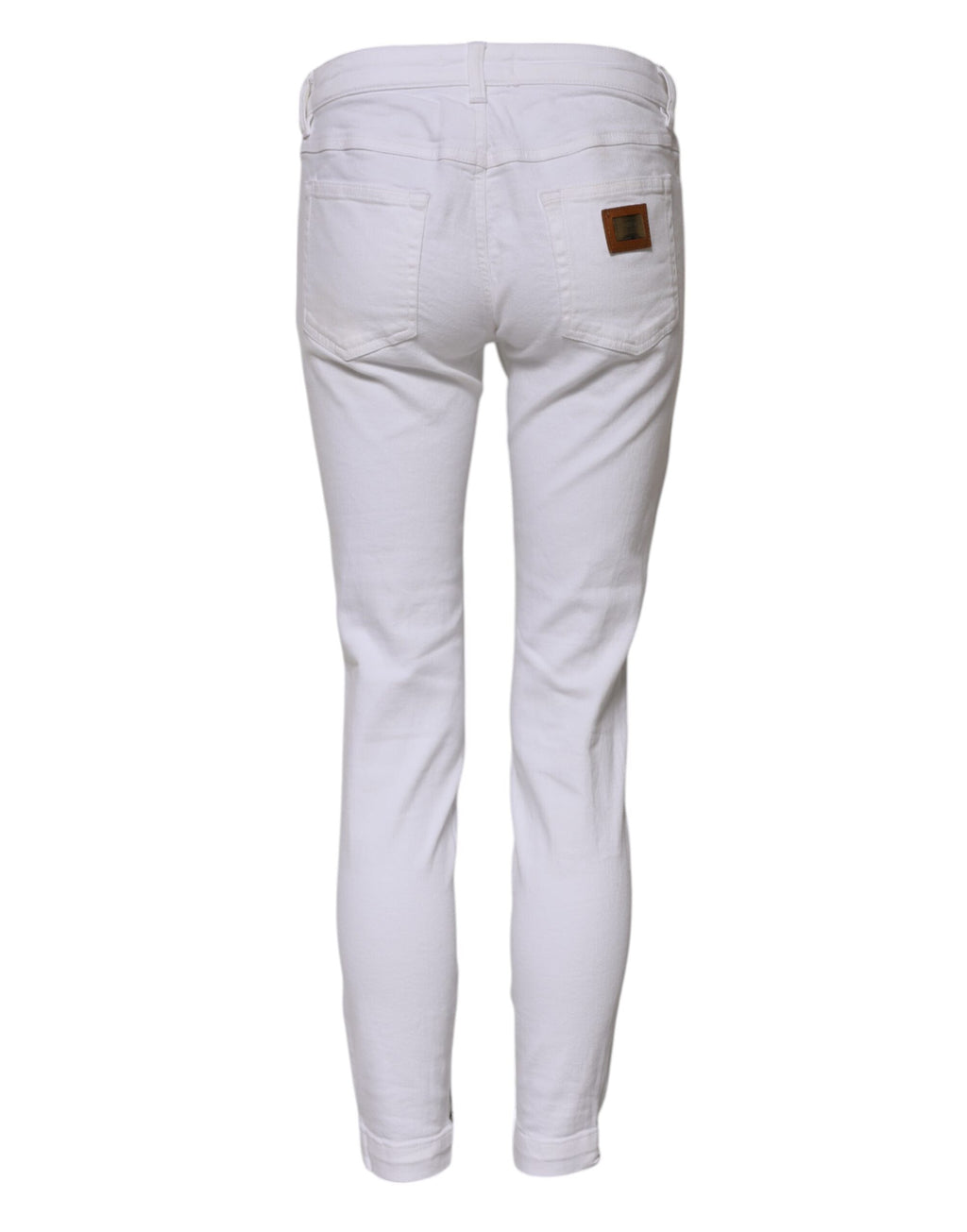 Jeans skinny en coton blanc à taille basse de Dolce & Gabbana, coupe ajustée et style moderne, visible sur l'image.