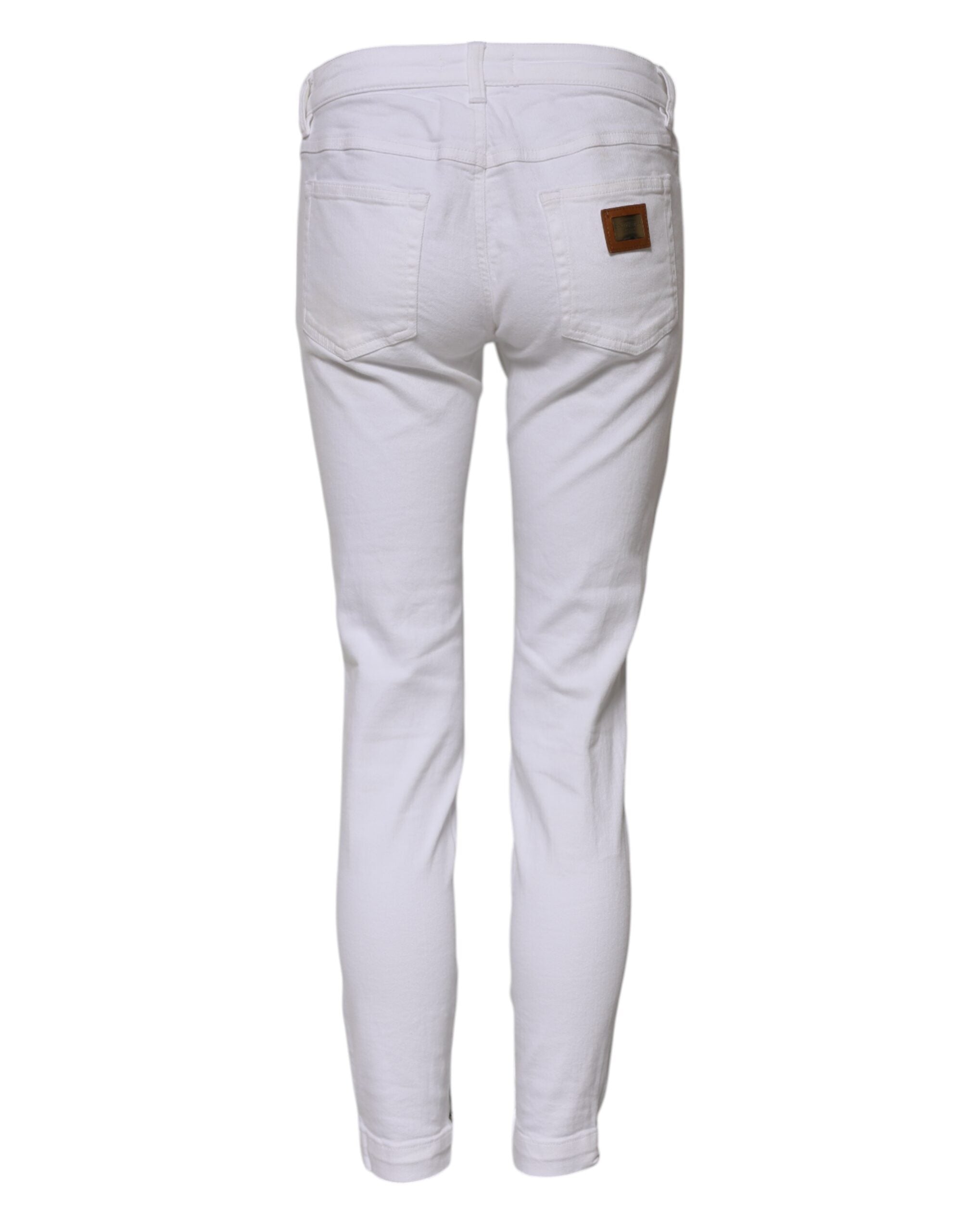 Jeans skinny en coton blanc à taille basse de Dolce & Gabbana, coupe ajustée et style moderne, visible sur l'image.