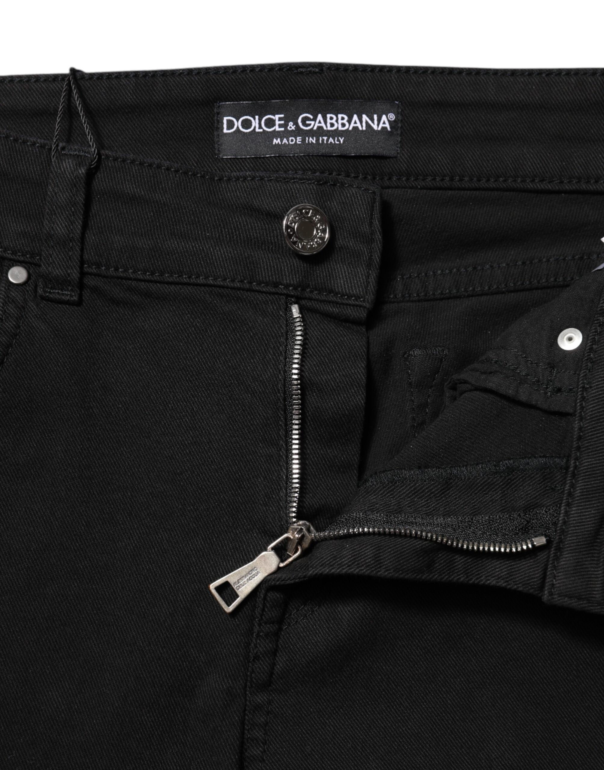 Jeans slim en coton noir Dolce & Gabbana avec logo, taille mi-haute, style denim ajusté, visible sur l'image.