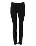 Jeans skinny en coton noir Dolce & Gabbana, taille mi-haute, coupe ajustée et moderne, visible sur le modèle.