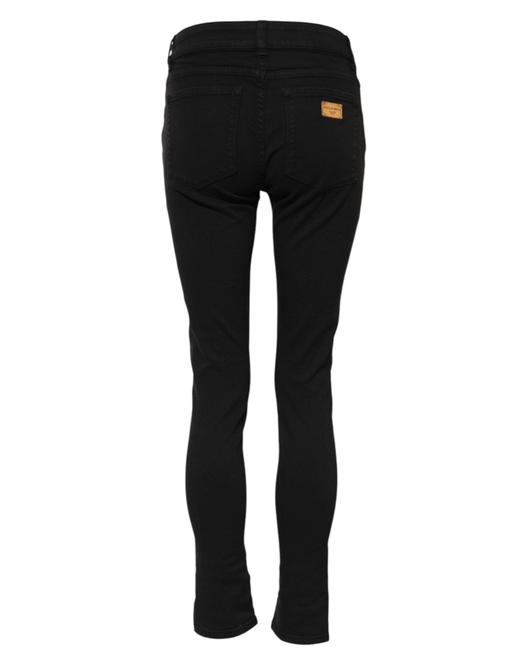 Jeans skinny en coton noir de Dolce & Gabbana, coupe mi-haute, style denim, visible sur un mannequin.