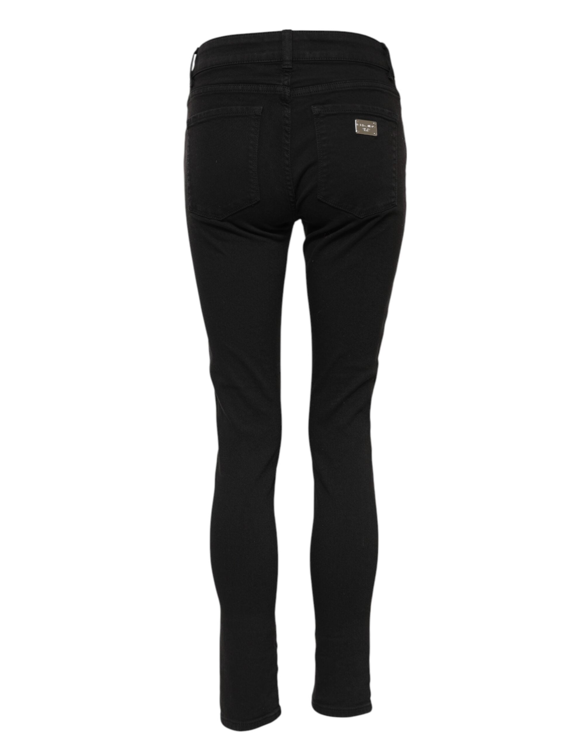 Jeans skinny en coton noir Dolce & Gabbana avec logo, taille mi-haute et coupe ajustée, visible sur l'image.