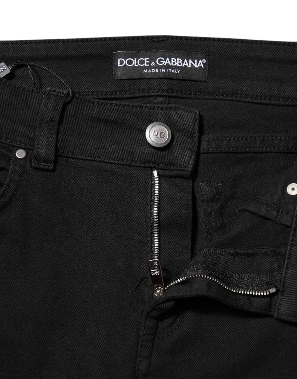 Jeans skinny en coton noir Dolce & Gabbana avec logo, taille mi-haute, denim tendance visible sur l'image.