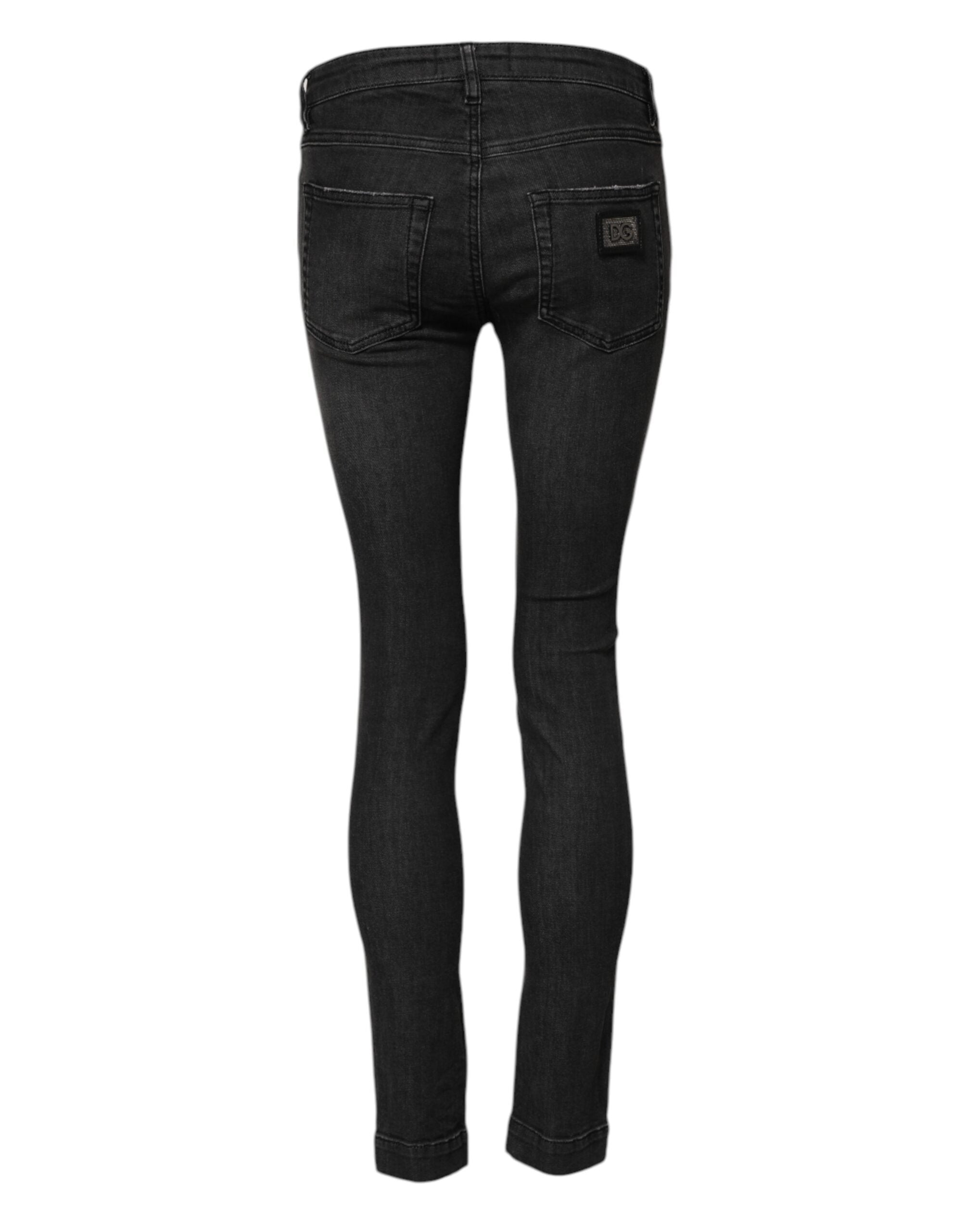 Jeans skinny en denim noir Dolce & Gabbana, taille basse, en coton, visible sur l'image.