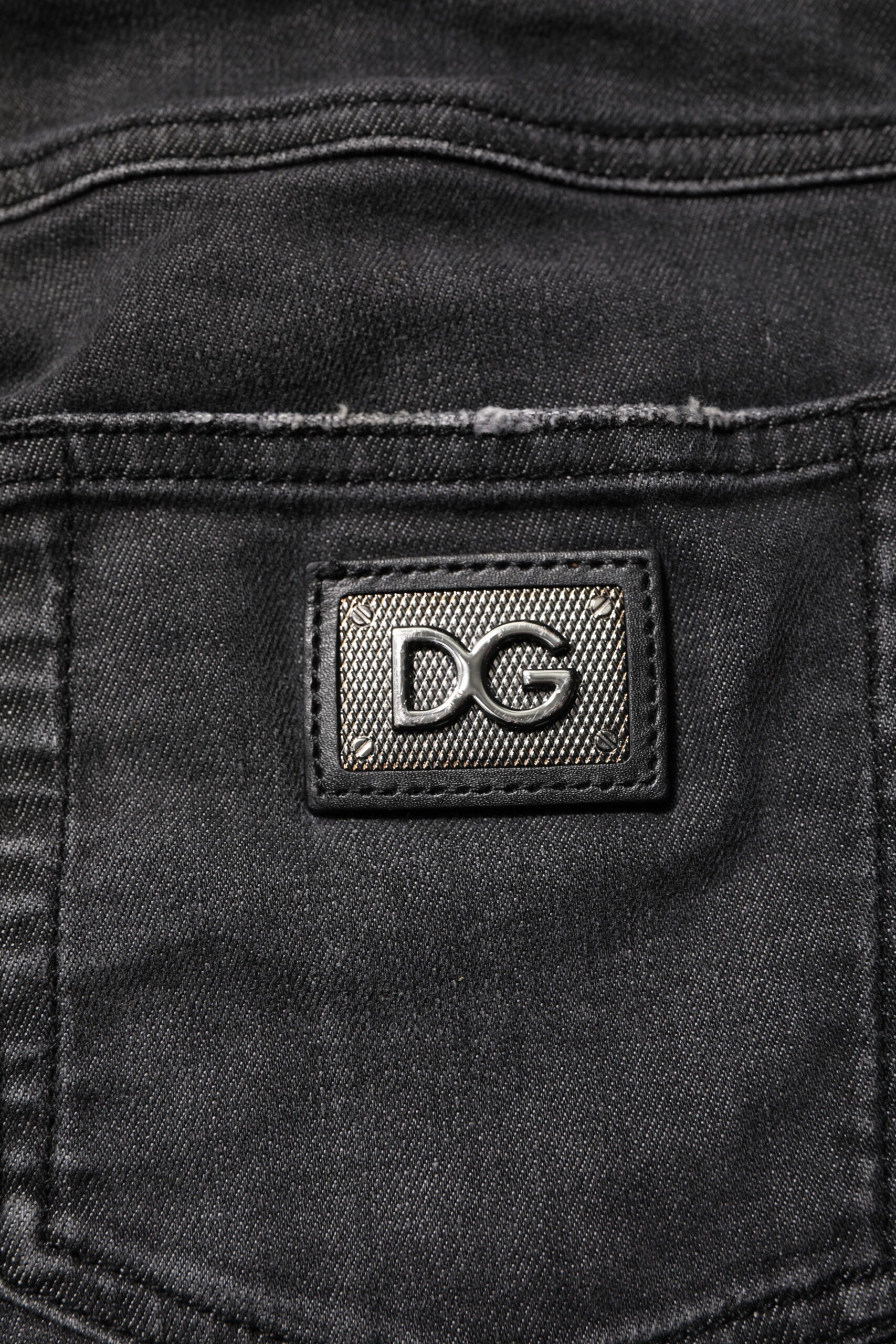 Jeans skinny en coton noir à taille basse de Dolce & Gabbana, coupe ajustée et détails classiques visibles sur l'image.