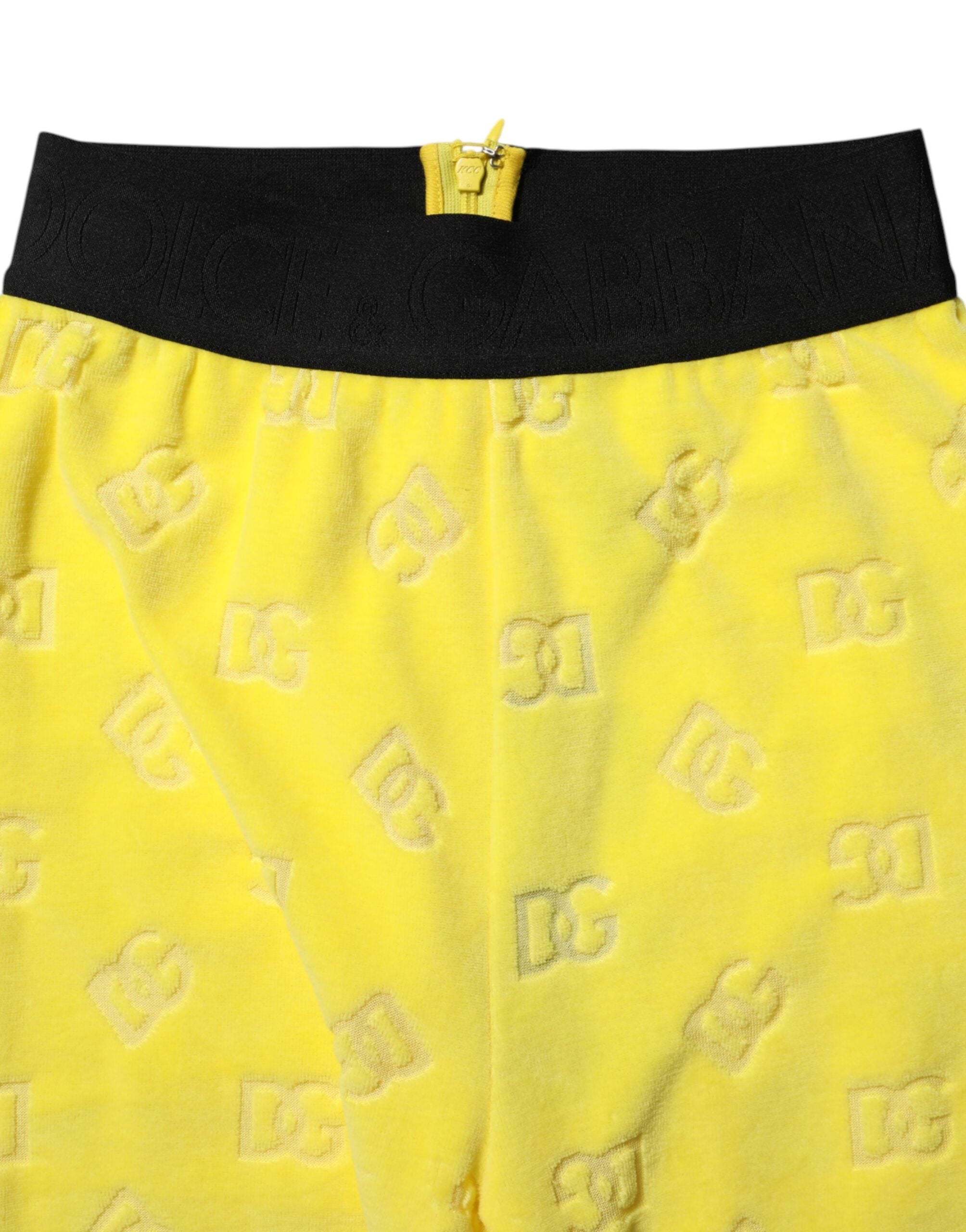 Leggings slim fit jaunes Dolce & Gabbana avec logo, tissu extensible et design élégant visible sur l'image.