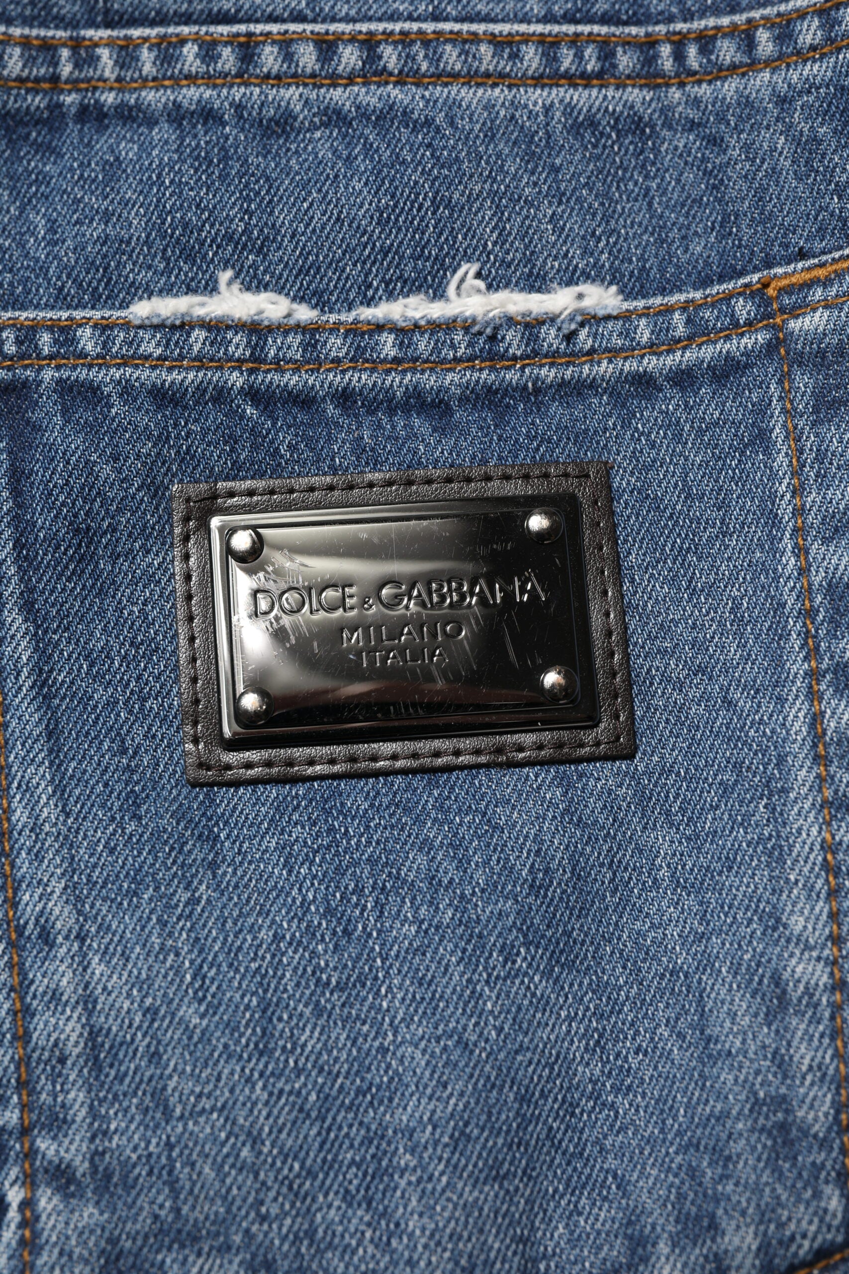 Jeans en denim droit tacheté en coton bleu Dolce & Gabbana, style décontracté avec déchirures et détails usés.